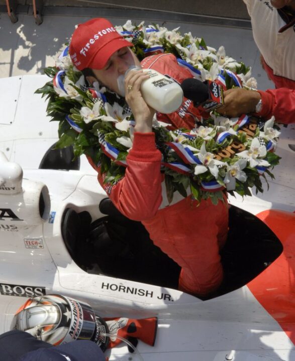 Sam Hornish Jr. lifts the bottle of milk as he stands in his car in Victory Circle following his victory in the Indianapolis 500 auto race at the Indianapolis Motor Speedway on Sunday, May 28, 2006, in Indianapolis. (AP Photo/Seth Rossman)