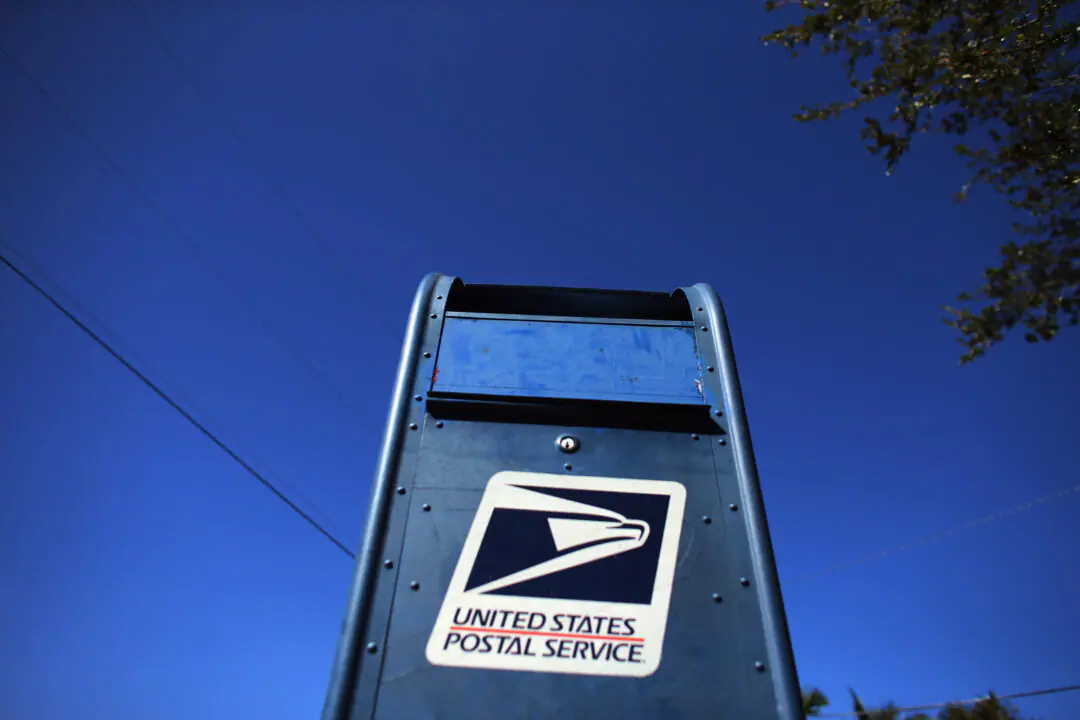 A U.S. Postal Service mailbox stands on November 15, 2012 in Miami, Florida. The Marion County Election Board is preparing to send out more than 10,000 absentee-by-mail ballots, with the first ballots arriving as early as next week. (Photo by Joe Raedle/Getty Images)