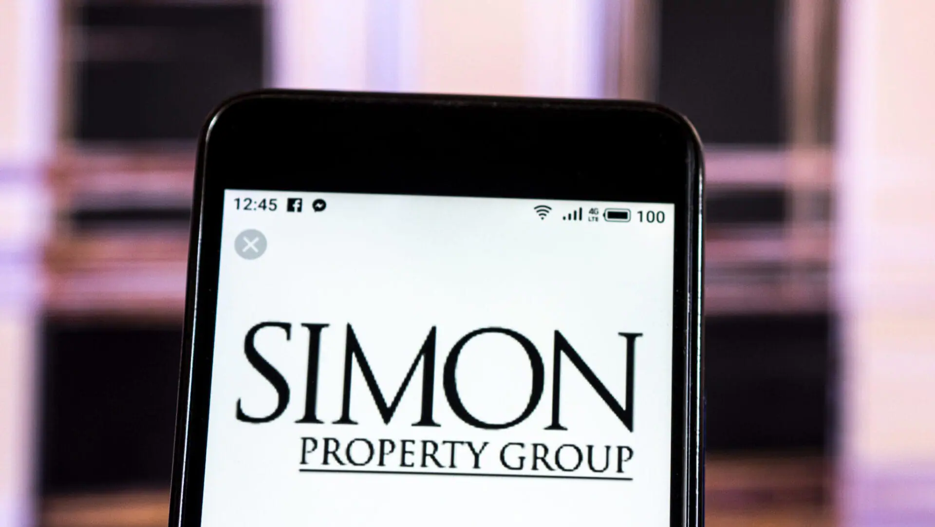 The Simon Property Group Real estate company logo is displayed on a smartphone. (Photo Illustration by Igor Golovniov/SOPA Images/LightRocket via Getty Images)