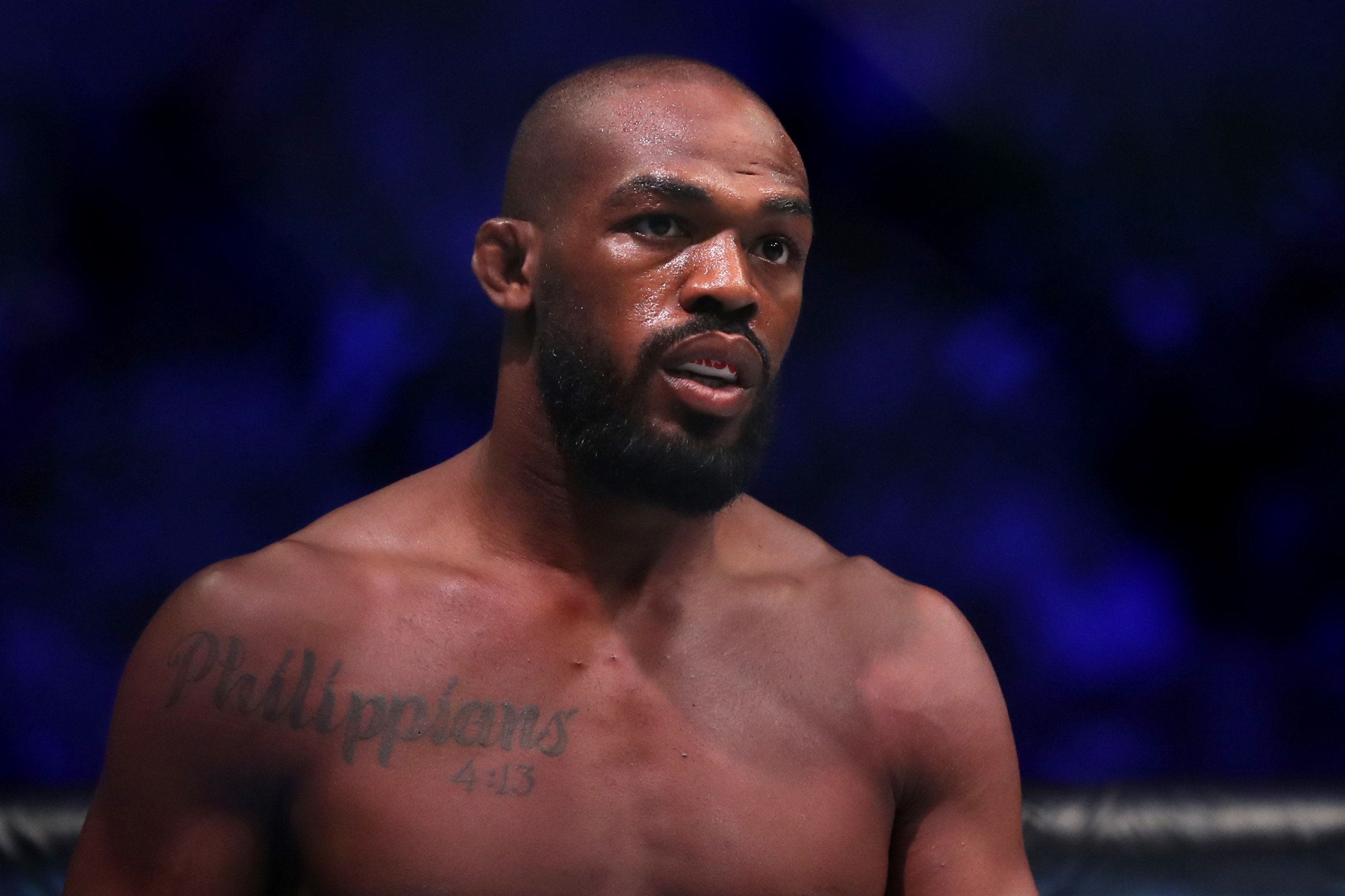 UFC fighter Jon Jones takes spray cans from demonstrators as protests