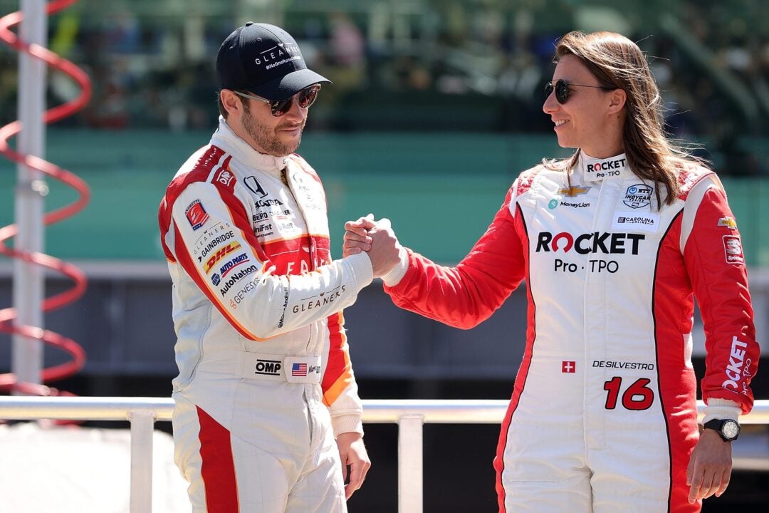 Marco Andretti of the United States, driver of the #98 Gleaners Food Bank of Indiana/Curb Andretti Herta-Haupert w/ Marco & Curb Agajanian, greets Simona de Silvestro of Switzerland, driver of the #16 Rocket Pro TPO/Paretta Autosport, prior to the 105th running of the Indianapolis 500 at Indianapolis Motor Speedway on May 30, 2021 in Indianapolis, Indiana. (Photo by Stacy Revere/Getty Images)