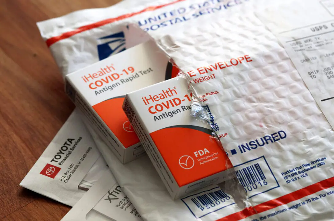 Free iHealth COVID-19 antigen rapid tests from the federal government sit on a U.S. Postal Service envelope after being delivered on Feb. 4, 2022. in San Anselmo, California. (Illustration by Justin Sullivan/Getty Images)