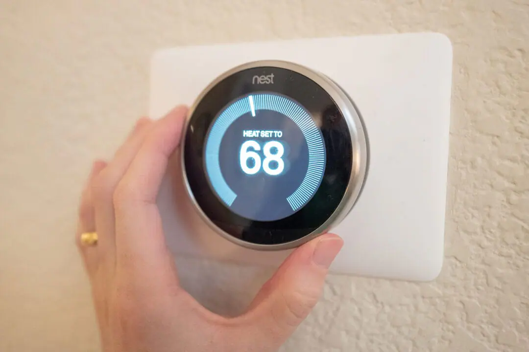 Close-up of hand of a man adjusting the heat setting on a Nest Learning Thermostat, an Internet of Things device from Google Inc, in a smart home in San Ramon, California, December 17, 2019. (Photo by Smith Collection/Gado/Getty Images)