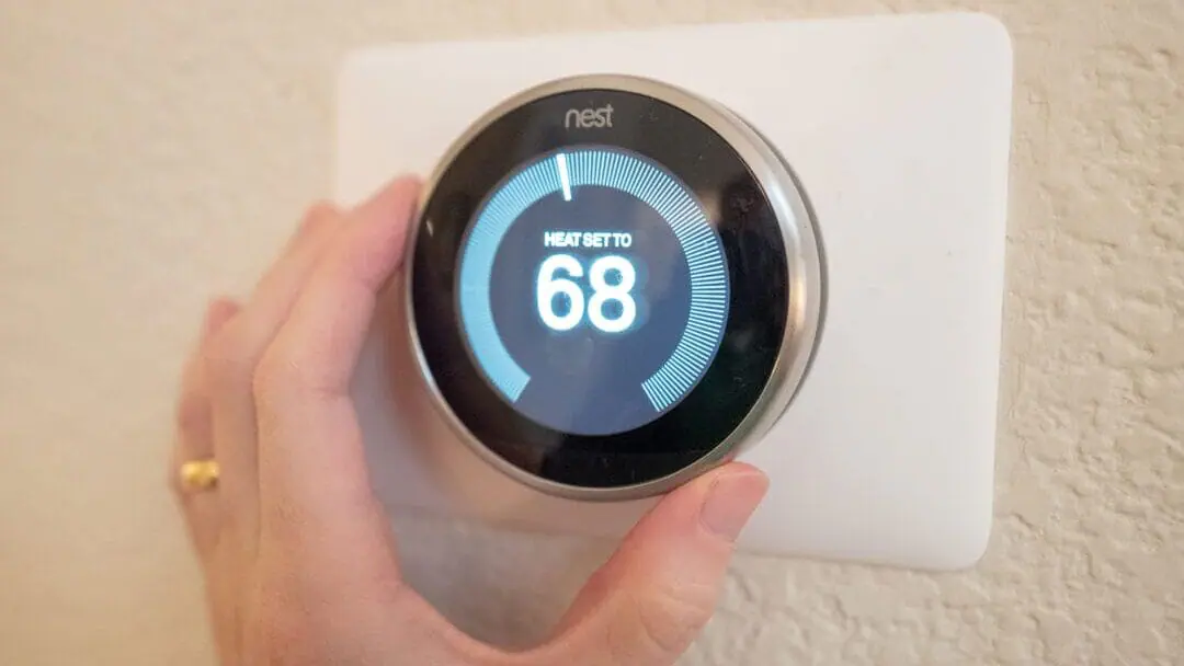 Close-up of hand of a man adjusting the heat setting on a Nest Learning Thermostat, an Internet of Things device from Google Inc, in a smart home in San Ramon, California, December 17, 2019. (Photo by Smith Collection/Gado/Getty Images)