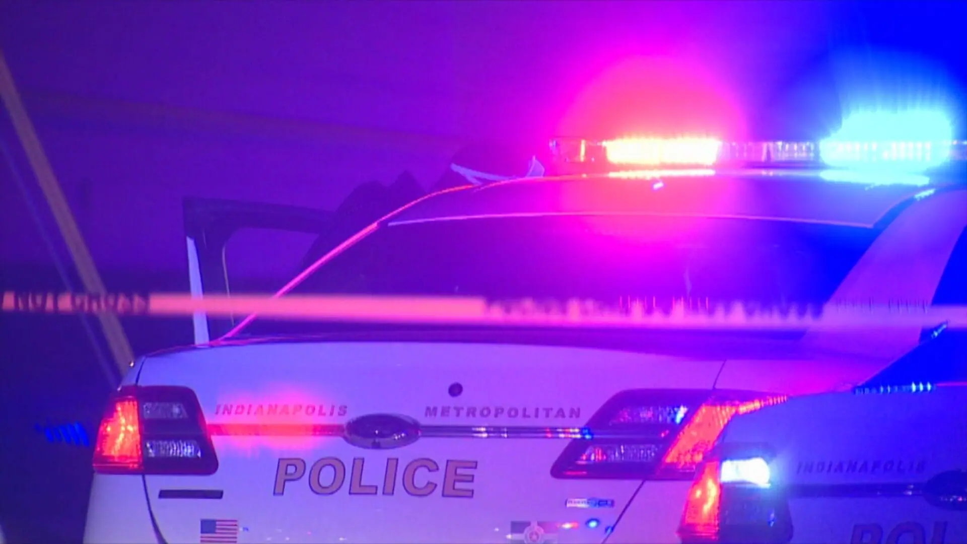 An IMPD patrol car with illuminated red and blue police lights on the roof. A man was found fatally shot at a home on Indianapolis' near northside by Crown Hill Cemetery on April 14, 2024.