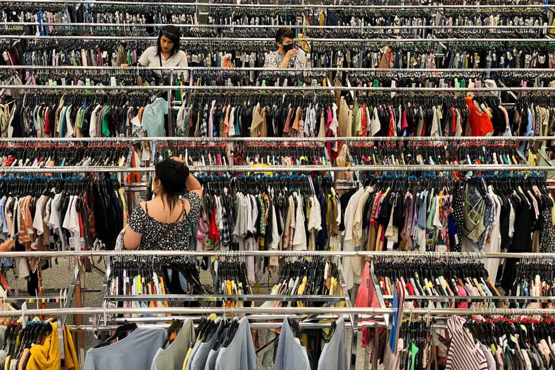 Customers browse racks of clothing as they shop inside a discount department retail store in Las Vegas, Nevada, on May 7, 2022. Most townships have programs that help families afford new school clothes for their kids. Requirements for assistance vary by township, but some offer hundreds of dollars for every child, depending on the amount of applicants.(Photo by PATRICK T. FALLON/AFP via Getty Images)