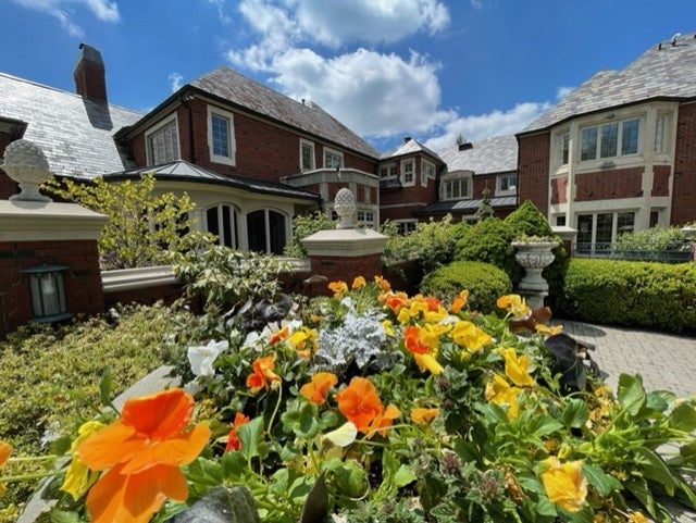 Landscaping outside the home with orange and yellow flowers