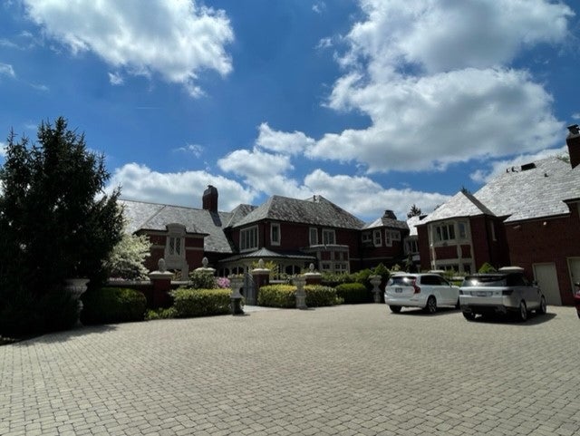 cars parked in the brick driveway