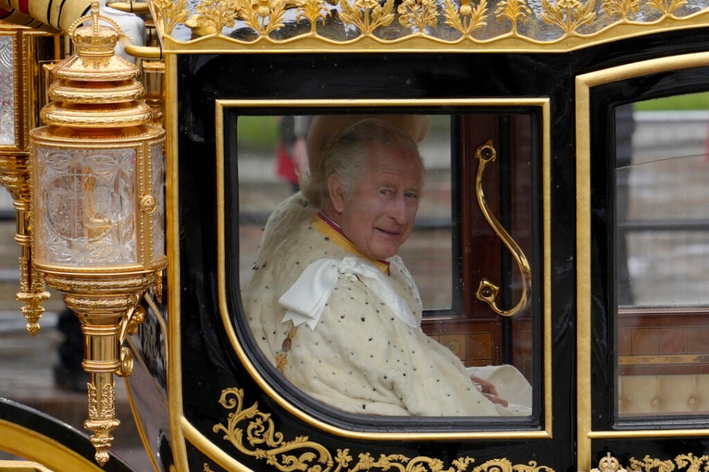 Britain's King Charles III and Camilla, the Queen Consort, are on the way to the coronation ceremony in London Saturday, May 6, 2023. (AP Photo/Vadim Ghirda)