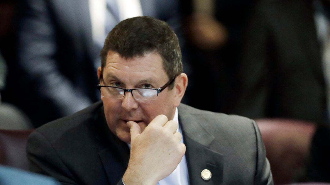 FILE - Indiana Rep. Jim Lucas, R-Seymour, listens during the start of the General Assembly session at the Statehouse, Jan. 3, 2018, in Indianapolis. A police report says the lawmaker’s pickup truck veered down a hill, across traffic lanes and through a guardrail on an interstate highway before he was arrested on a drunken driving charge. The terms of his probation were ended early on Dec. 9, a motion filed in Jackson Superior Court saying he completed the terms of his probation and paid all fees. (AP Photo/Darron Cummings, File)