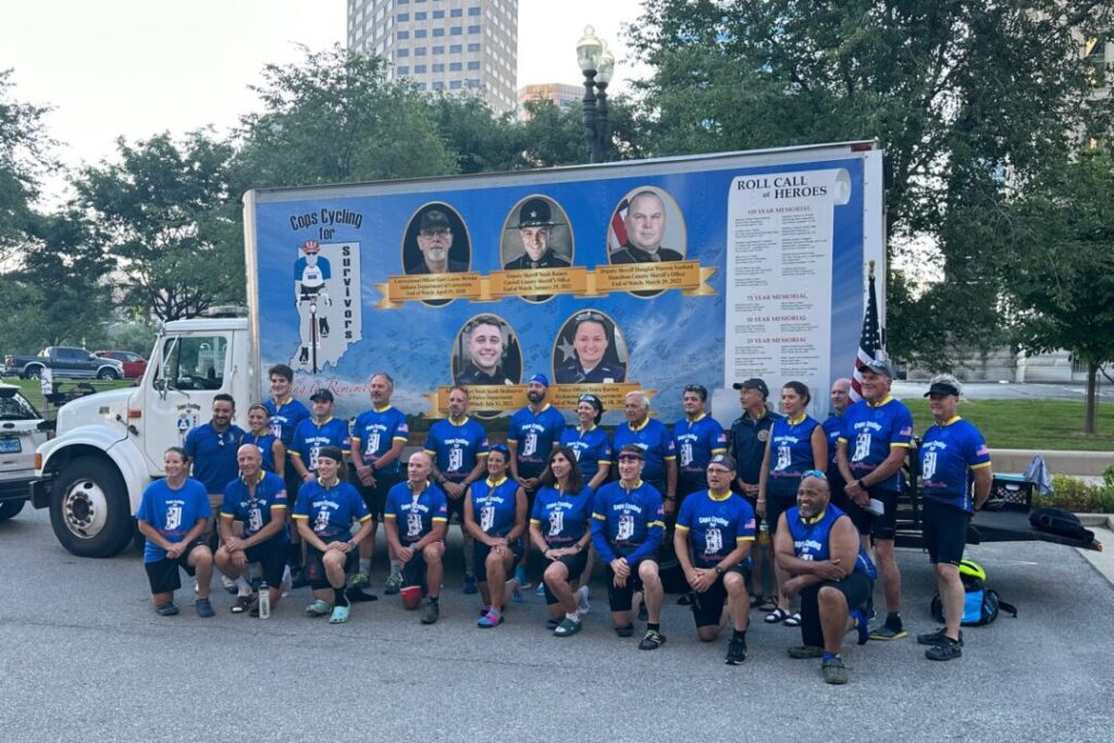 Riders taking part in Cops Cycling for Survivors pose before the 22nd annual ride on July 10, 2023. (WISH Photo/Hanna Mordoh)