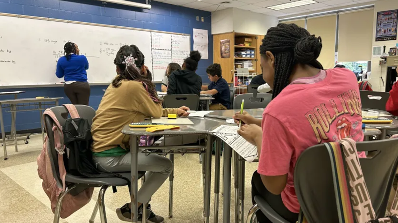 Sixth grade math teacher Brashon Porter with students at James Whitcomb Riley School 43 on Aug. 30, 2023. School 43 ha a new principal and a new agreement with community members to help uplift the low-performing school.Amelia Pak-Harvey / Chalkbeat