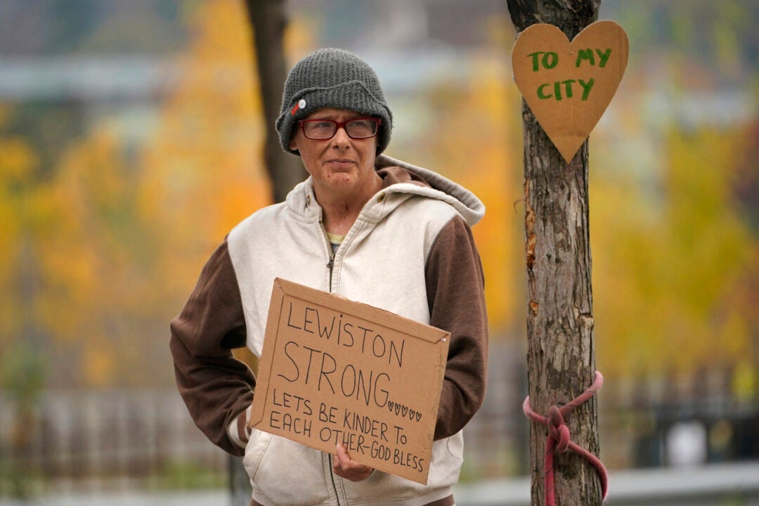 Jess Paquette expresses her support for her city in the wake of Wednesday's mass shootings at a restaurant and bowling alley, Thursday, Oct. 26, 2023, in Lewiston, Maine. Authorities have not released the victims' names, but their family members have been confirming their deaths.(AP Photo/Robert F. Bukaty)