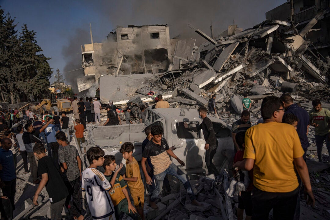 Palestinians look for survivors following an Israeli airstrike in Khan Younis refugee camp, southern Gaza Strip, Tuesday, Nov. 7, 2023. (AP Photo/Fatima Shbair)