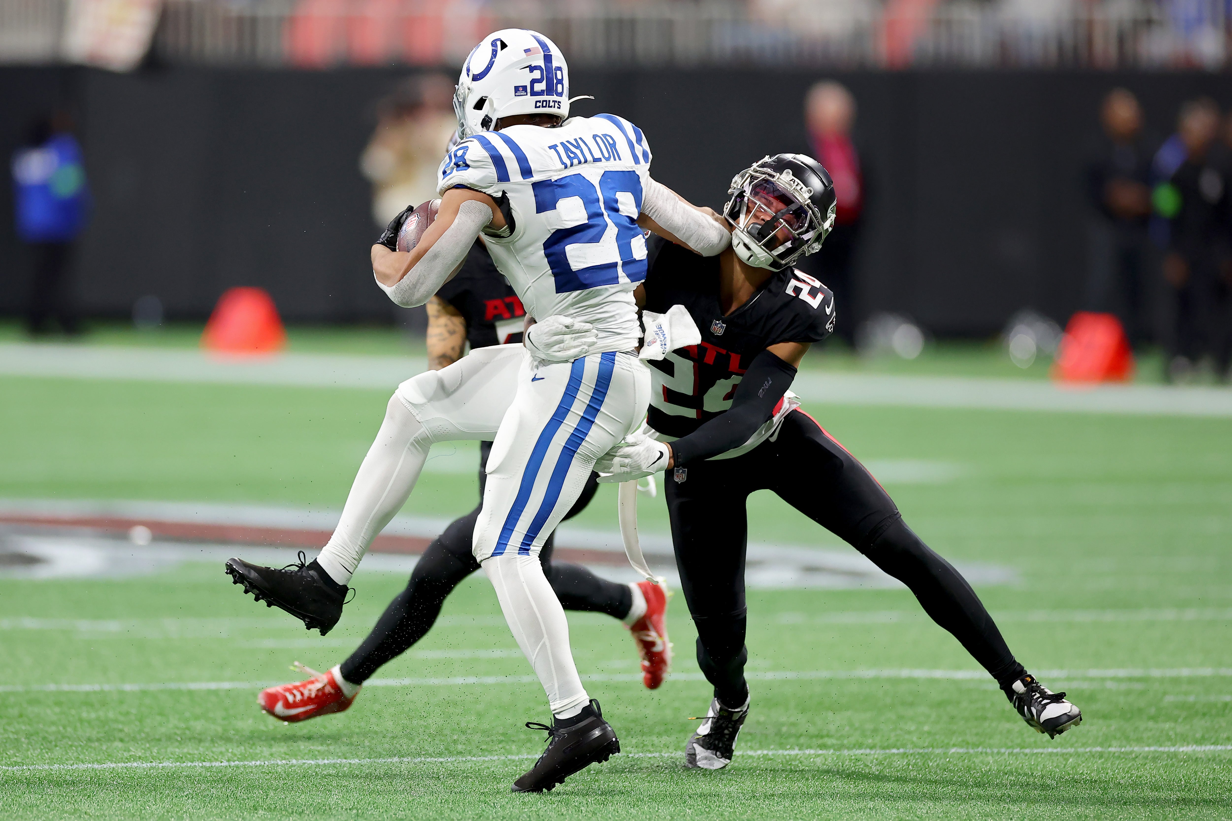 ATLANTA, GEORGIA - DECEMBER 24: Jonathan Taylor #28 of the Indianapolis Colts is tackled by A.J. Terrell #24 of the Atlanta Falcons during the second quarter at Mercedes-Benz Stadium on December 24, 2023 in Atlanta, Georgia. (Photo by Kevin C. Cox/Getty Images)