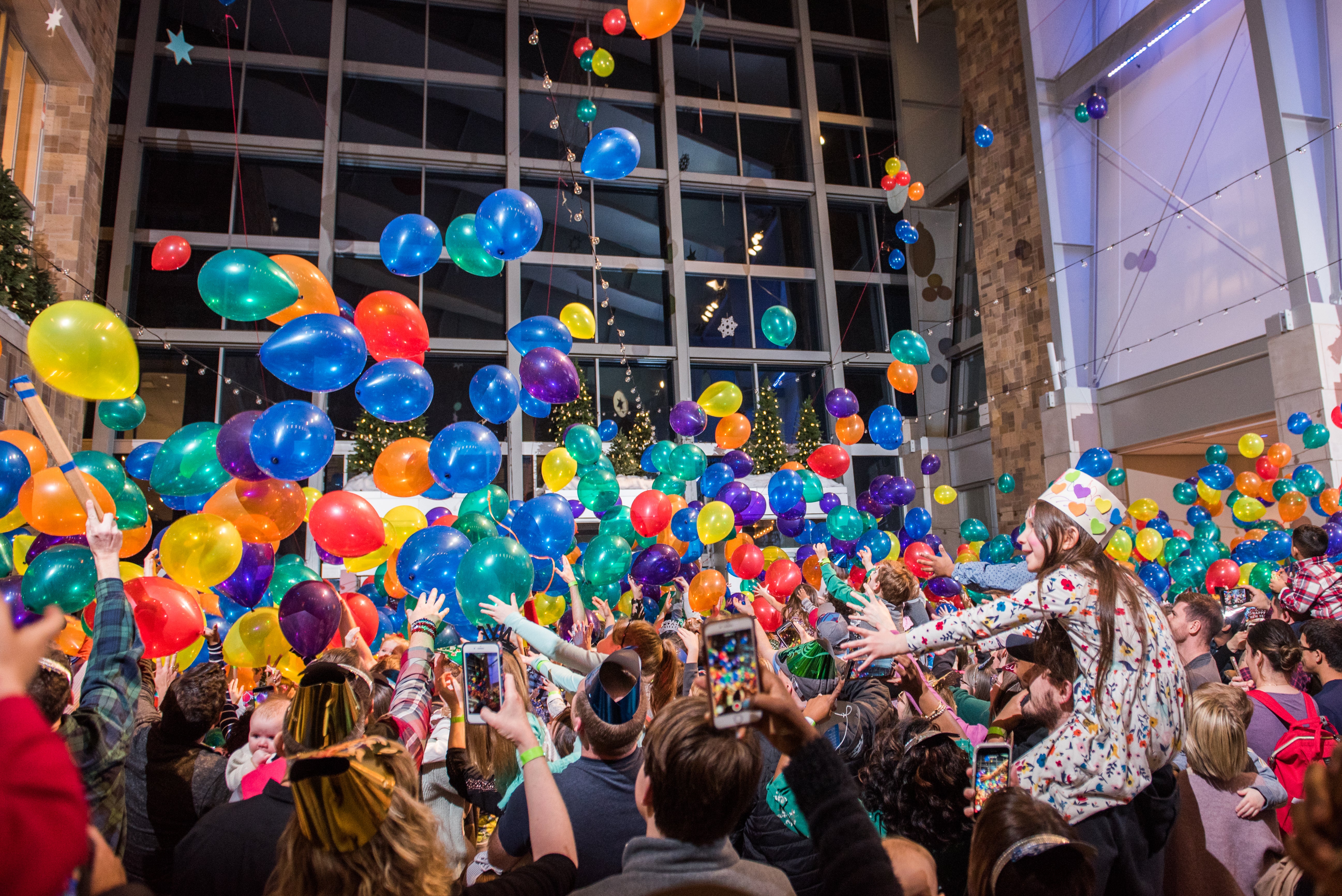 Families and kids celebrate the arrival of a new year during a family-friendly balloon drop at the Indiana State Museum. (Provided Photo/Amy Payne/Indiana State Museum)