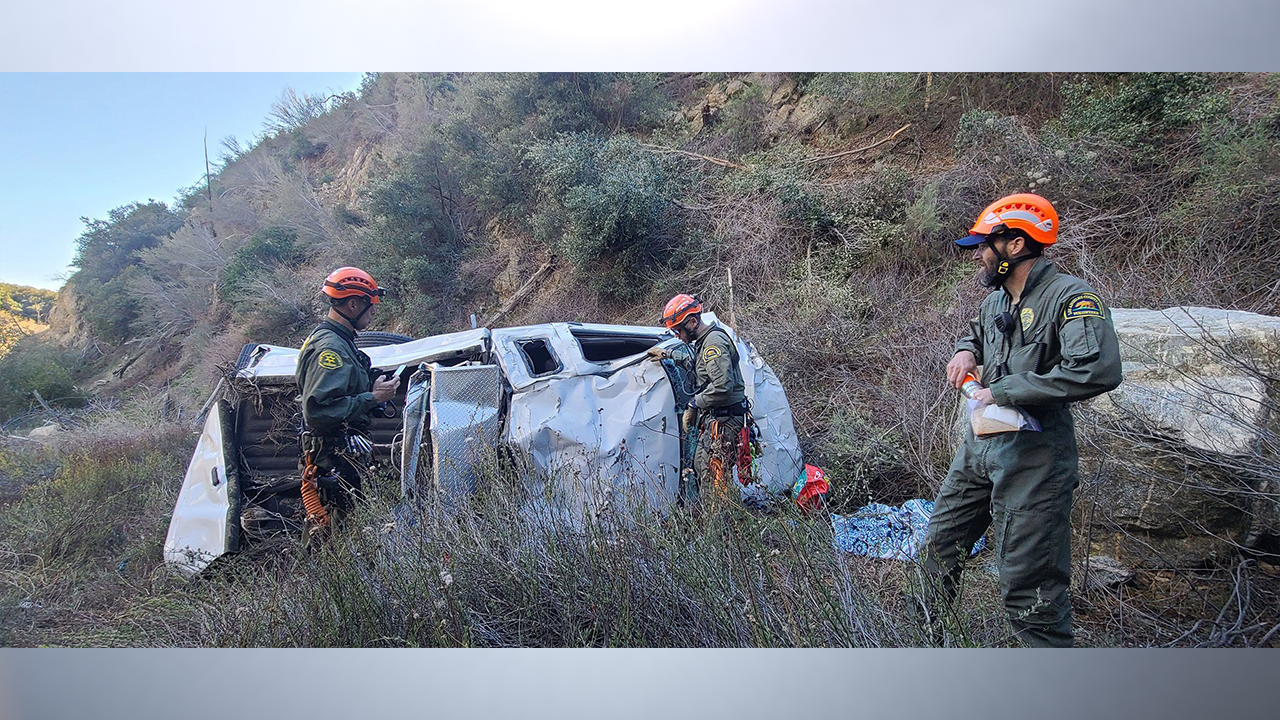 Members of the San Dimas Mountain Rescue Team investigate a crash scene near Mount Baldy Road in California. A woman survived 4 nights in the mountains after she swerved to miss a deer and her truck went into a canyon. (Photo by San Dimas Mountain Rescue Team via CNN)