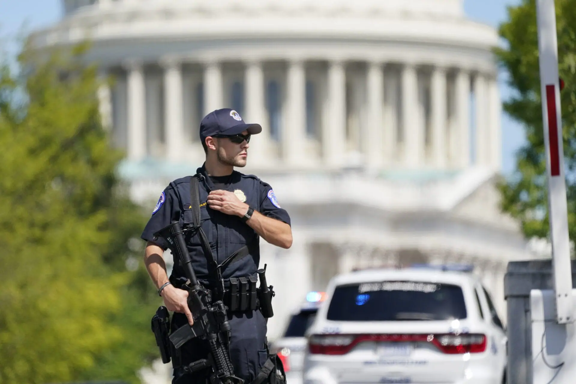 A U.S. Capitol Police officer stands at an intersection near the U.S. Capitol and a Library of Congress building in Washington on Thursday, Aug. 19, 2021, as law enforcement investigate a report of a possible explosive device in a pickup truck outside the Library of Congress on Capitol Hill. (AP Photo/Patrick Semansky)