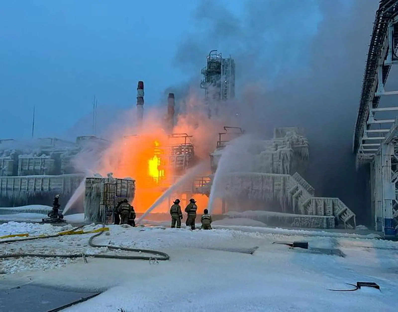 Firefighters work to extinguish a fire at a terminal belonging to Novatek, Russia's largest liquefied natural gas producer, in the port of Ust-Luga, Russia, on Sunday