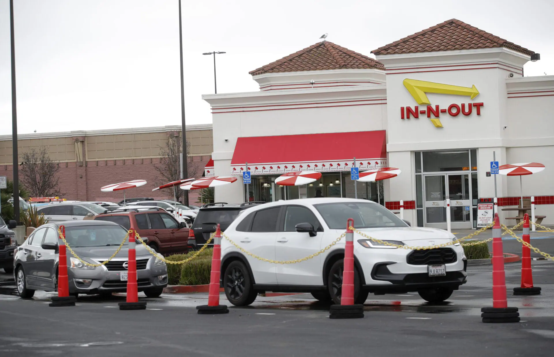 Customers line up at the In-N-Out drive-thru off Hegenberger Road in Oakland, Calif., on Monday, Jan. 22, 2024. In-N-Out will close its only restaurant in Oakland because of a wave of car break-ins, property damage, theft and armed robberies targeting customers and employees alike, the company announced. The burger joint in a busy corridor near the Oakland International Airport will close on March 24, 2024.