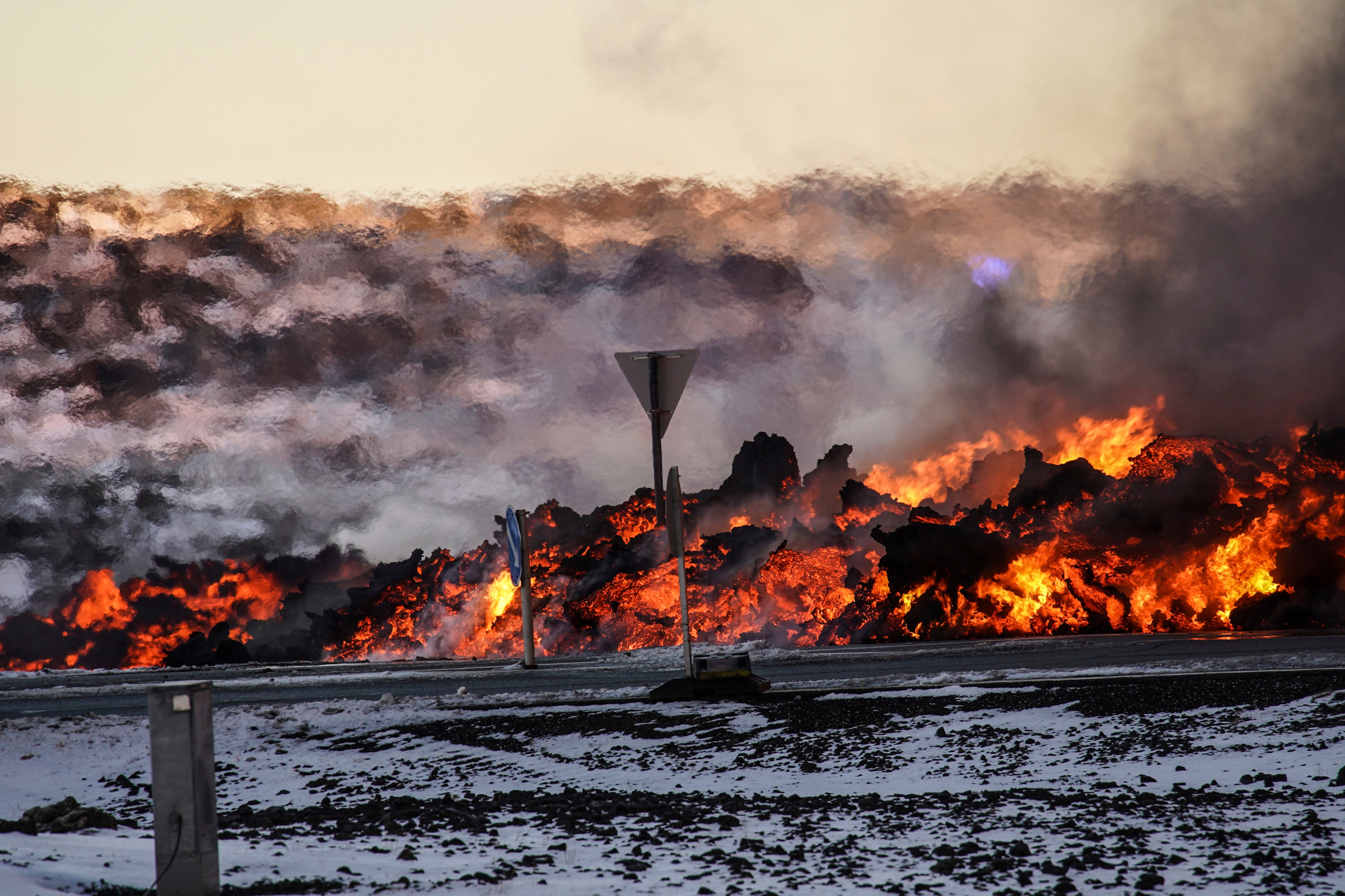 A view of lava near to the road to Grindavík, close to the exit for the blue lagoon, in Grindavík, Iceland, Thursday, Feb. 8, 2024. A volcano in southwestern Iceland has erupted for the third time since December and sent jets of lava into the sky. The eruption on Thursday morning triggered the evacuation the Blue Lagoon spa which is one of the island nation’s biggest tourist attractions. (AP Photo /Marco Di Marco)