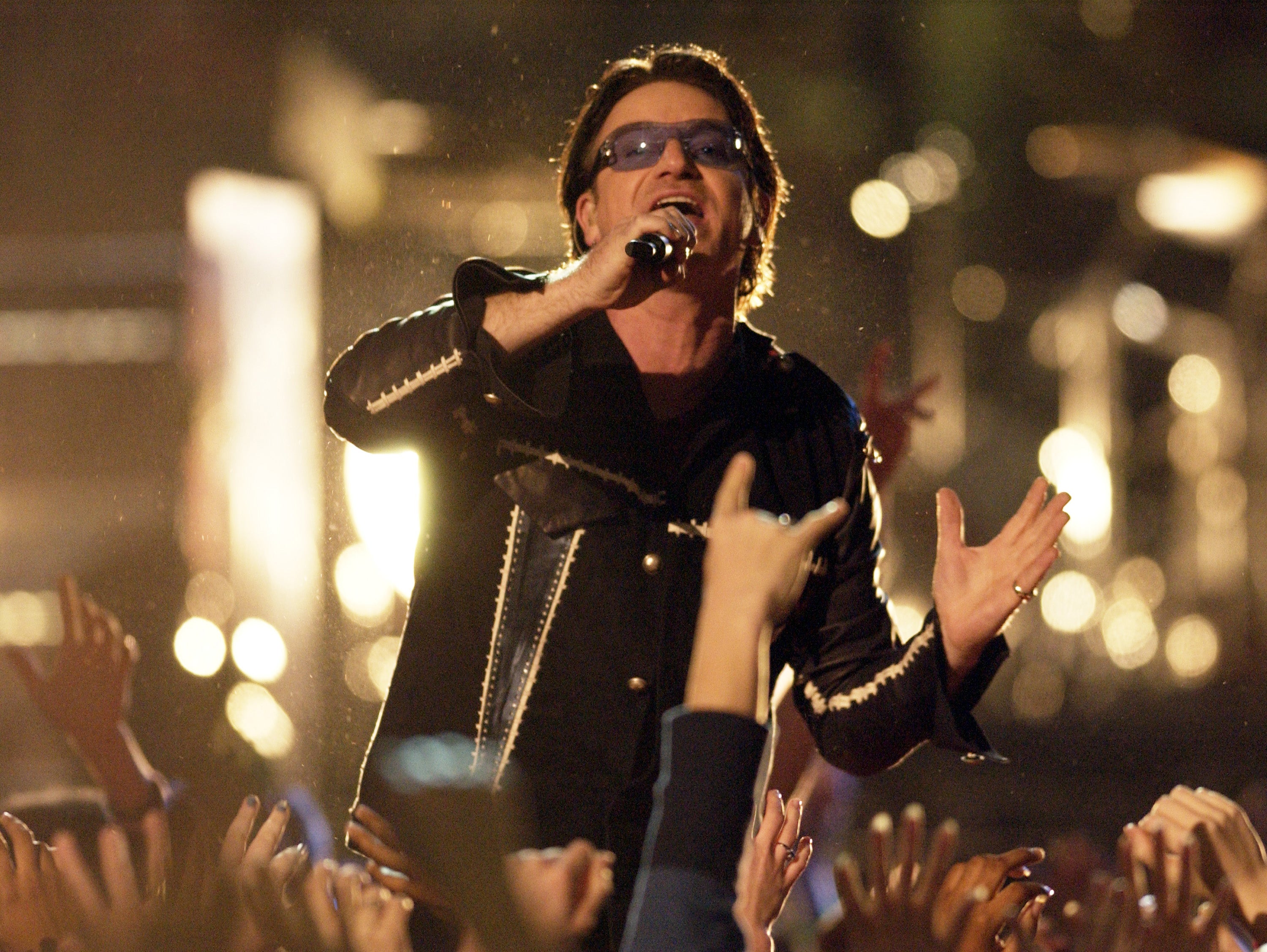 Bono, lead singer of U2, performs during the halftime show at Super Bowl XXXVI in the Superdome, New Orleans, Louisiana, February 3, 2002. (Photo by Theo Wargo/WireImage)