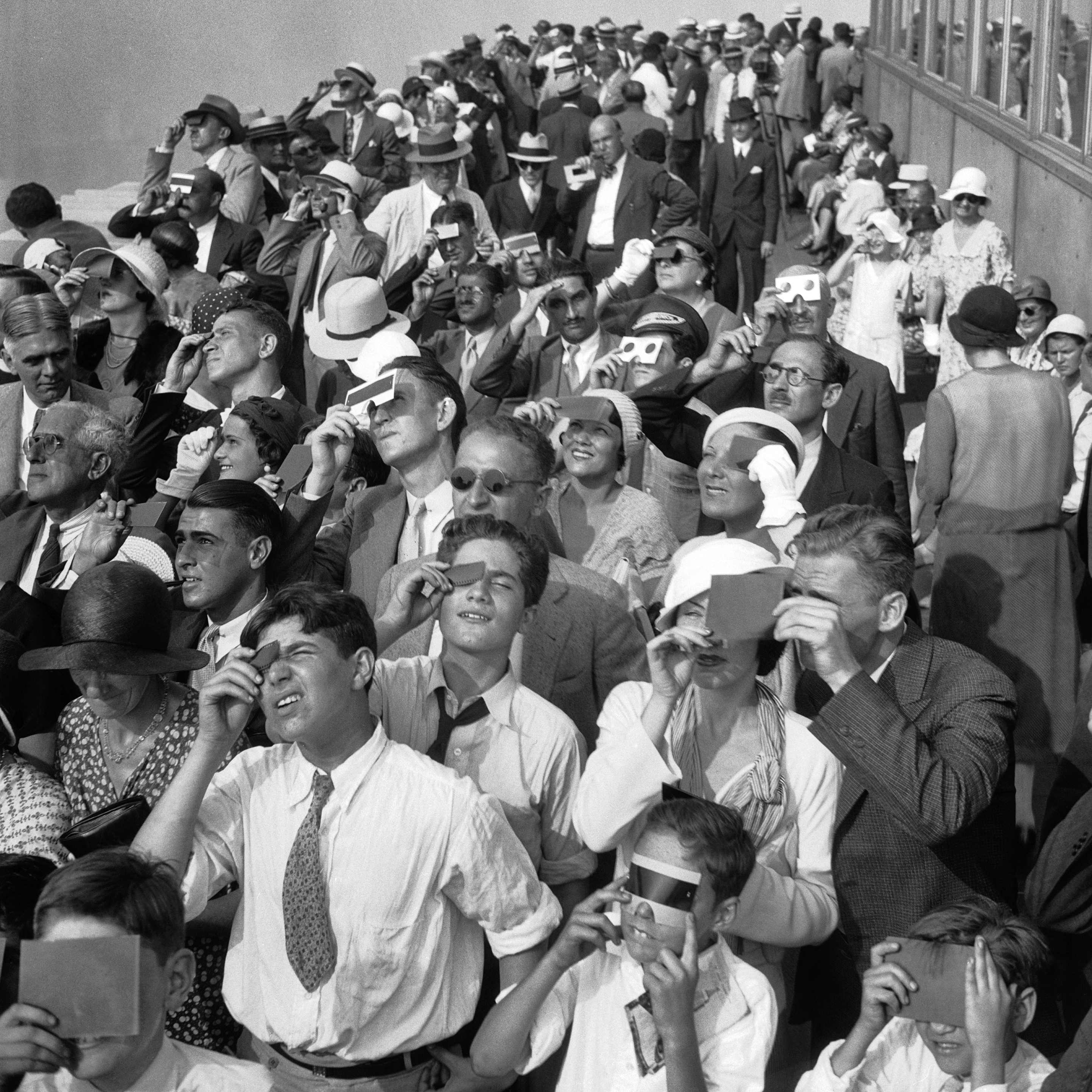 Indiana's total solar eclipse is less than 50 days away! Here's a look at how people enjoyed total solar eclipses in years past. Eclipse watchers squint through protective filters as they view an eclipse of the sun from the top deck of New York's Empire State Building in New York on Wednesday, Aug. 31, 1932. (AP Photo/File, File)