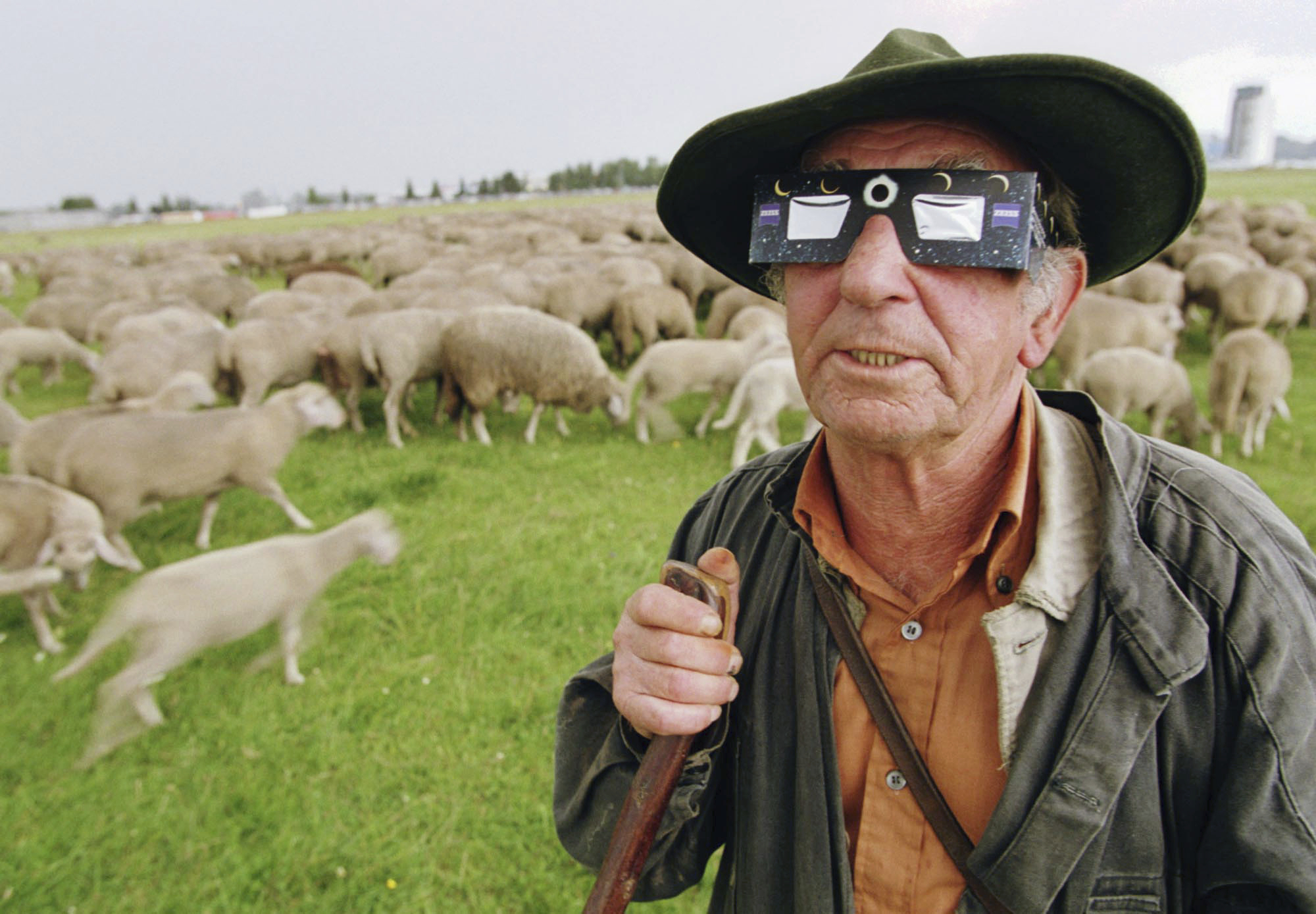 Shepherd Heinz Greiner watches the beginning of a total solar eclipse near Augsburg, southern Germany, on Wednesday, Aug. 11, 1999. (AP Photo/Frank Boxler, File)