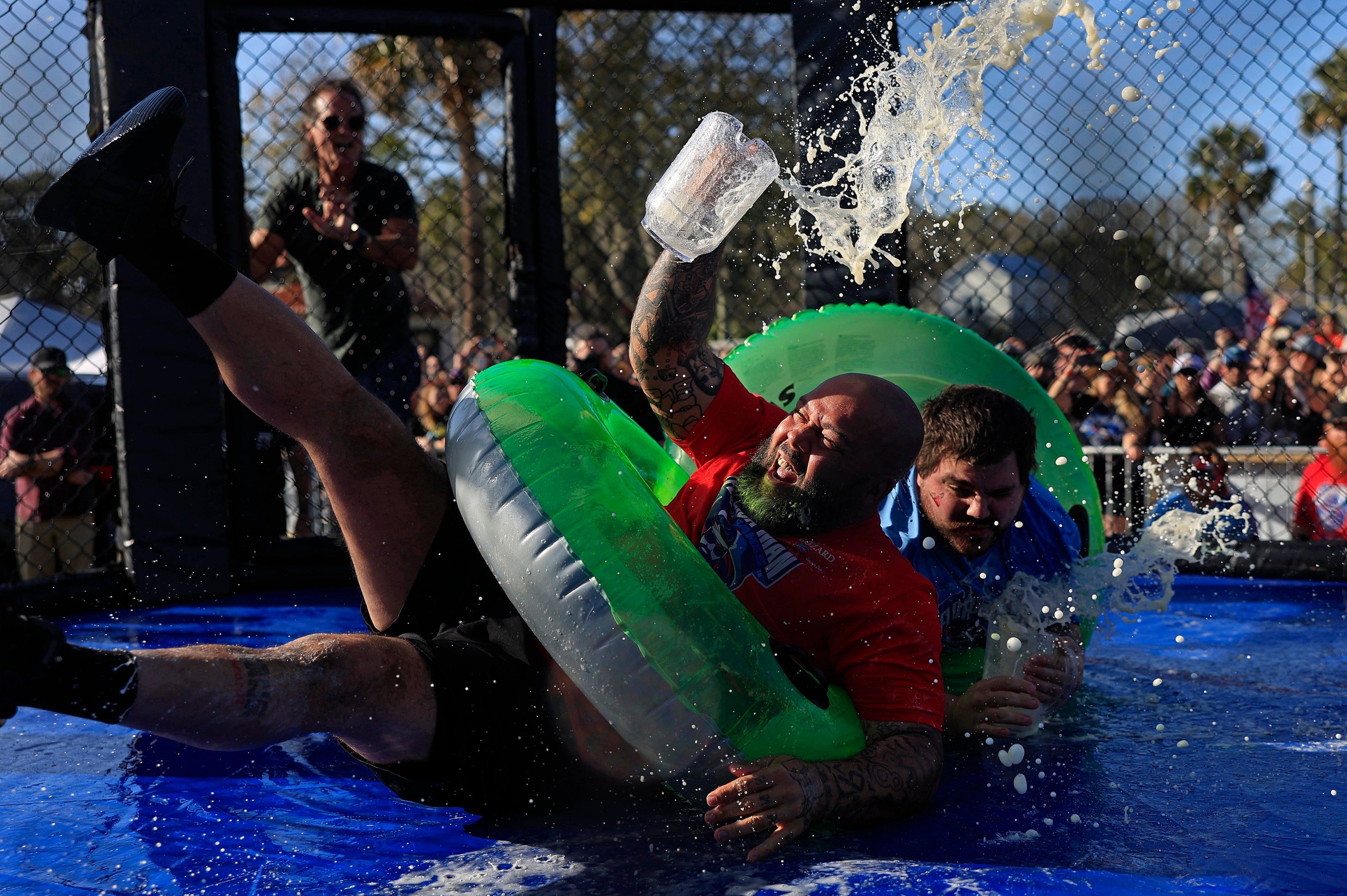 Jon Davis, left, loses his footing and most of his beer against Gary 