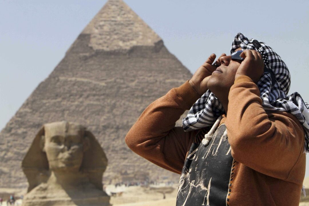 A man uses special glasses to view a partial solar eclipse as people gather near the Sphinx at the Giza Pyramids on the outskirts of Cairo, Egypt, Friday, March 20, 2015. The partial eclipse was visible across Europe and parts of Asia and Africa, while sky-gazers in the Arctic were treated to a perfect view of a total solar eclipse as the moon completely blocked out the sun in a clear sky. (AP Photo/Khaled Kamel, File)