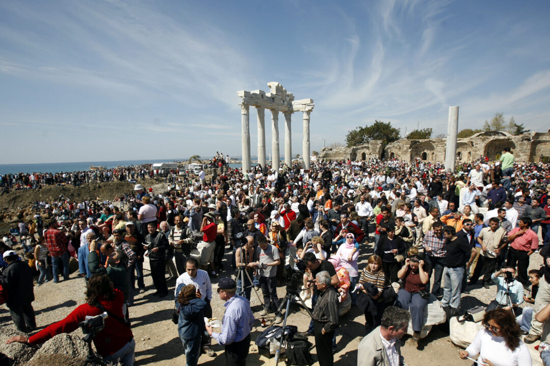 Thousands of tourists gather to view a solar eclipse in front of Apollo Temple in the Turkish Mediterranean coastal resort of Side, Turkey, Wednesday March 29, 2006. (AP Photo/Burhan Ozbilici, File)
