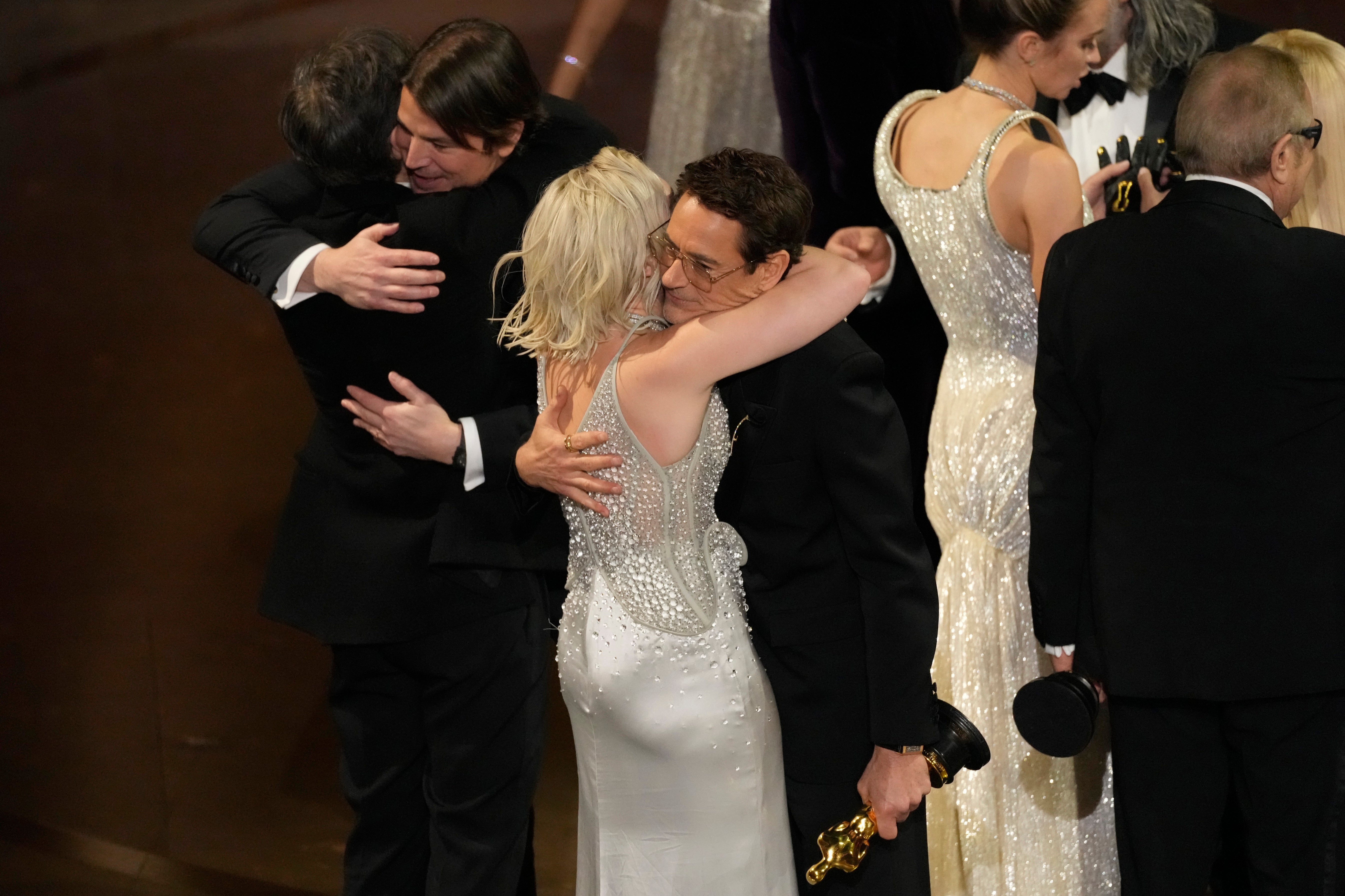 Cillian Murphy, from left, Josh Hartnett, Florence Pugh, and Robert Downey Jr. embrace as 