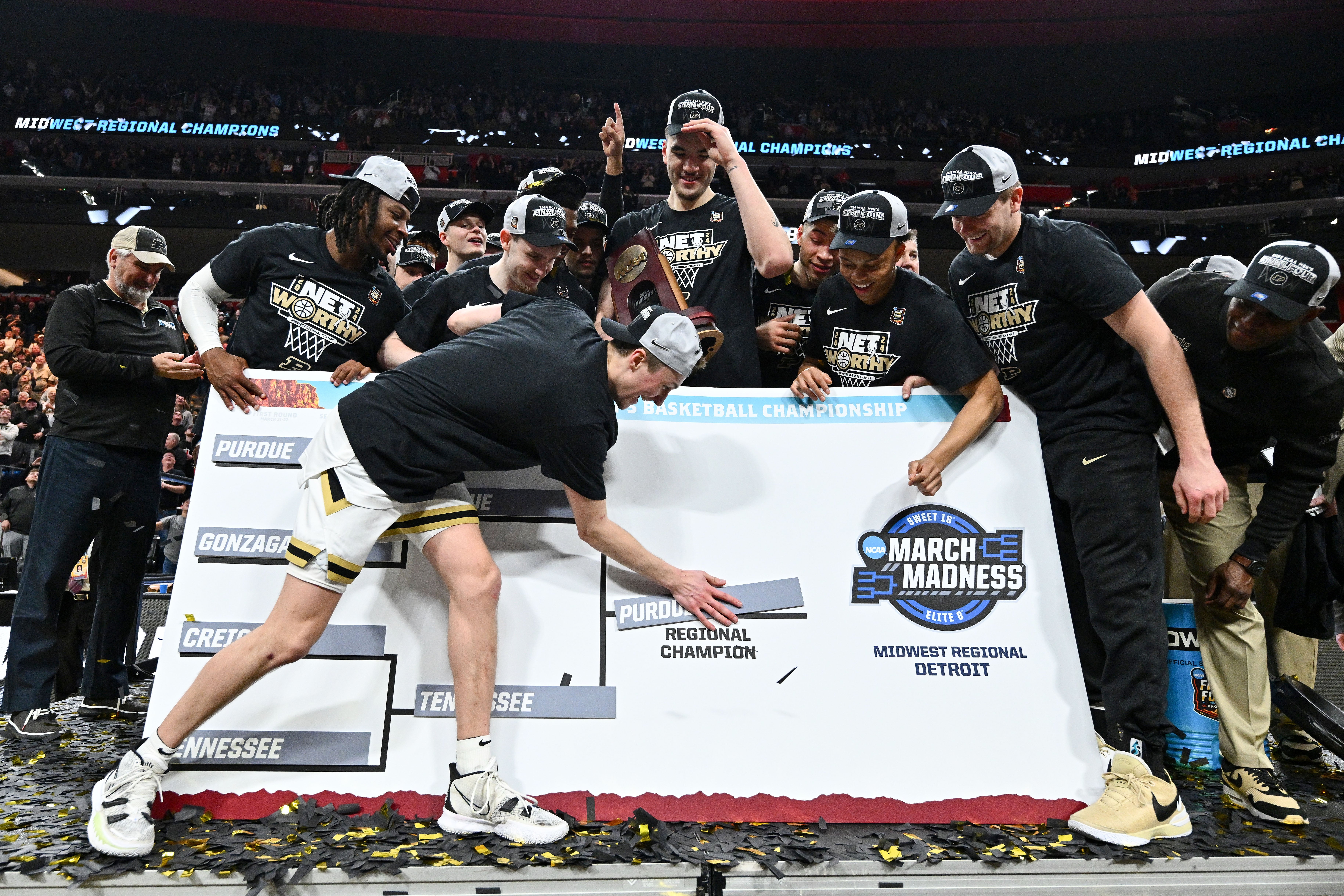 Fletcher Loyer #2 of the Purdue Boilermakers places the 'Purdue' marker on the Regional Champion slot on the bracket after their win against the Tennessee Volunteers during the Elite Eight round of the 2024 NCAA Men's Basketball Tournament held at Little Caesars Arena on March 31, 2024 in Detroit, Michigan. (Photo by Jamie Sabau/NCAA Photos via Getty Images)