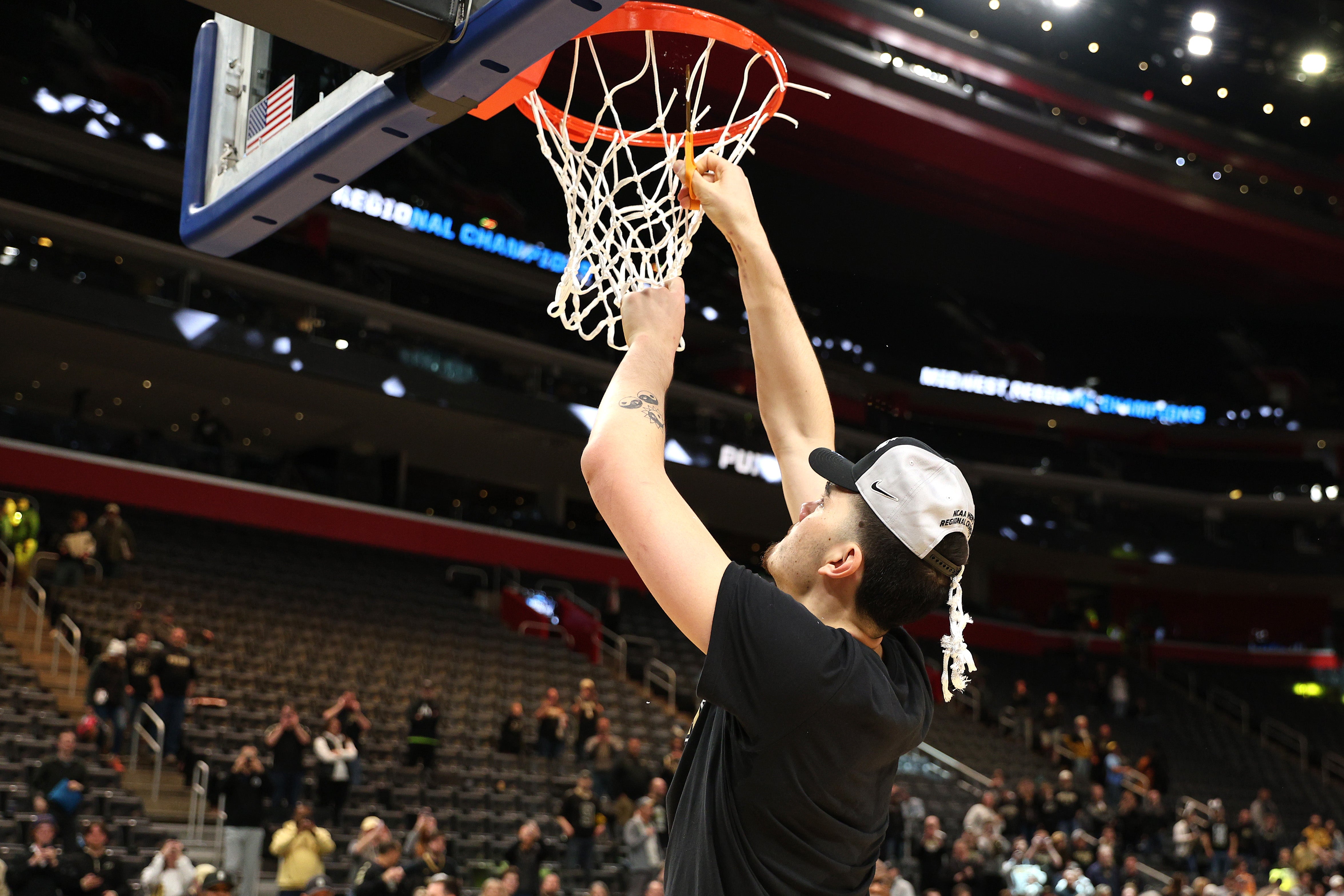 Zach Edey #15 of the Purdue Boilermakers cuts down the net after defeating the Tennessee Volunteers in the Elite 8 round of the NCAA Men's Basketball Tournament at Little Caesars Arena on March 31, 2024 in Detroit, Michigan. (Photo by Mike Mulholland/Getty Images)