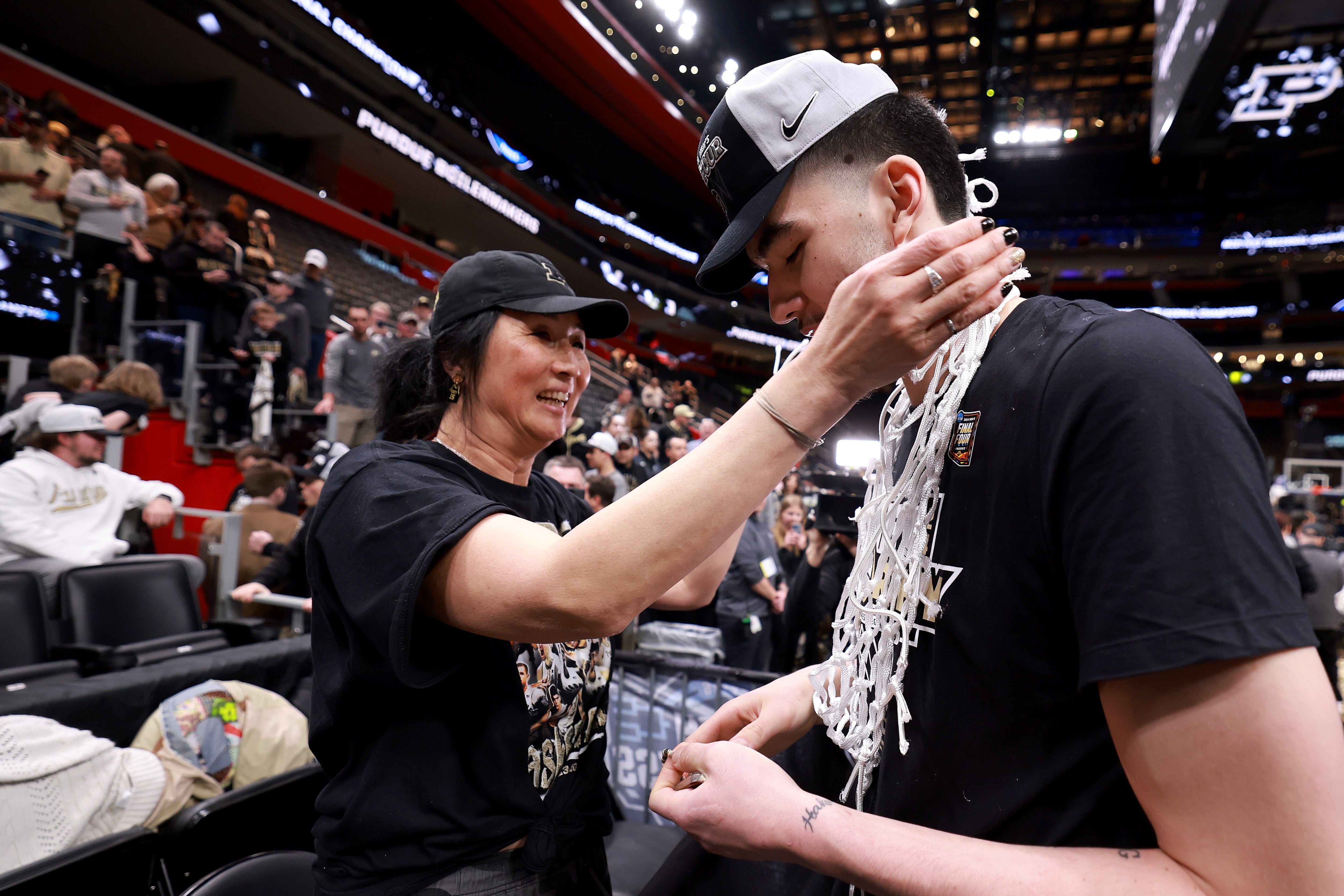 Zach Edey #15 of the Purdue Boilermakers celebrates with his mother Julia after defeating the Tennessee Volunteers in the Elite 8 round of the NCAA Men's Basketball Tournament at Little Caesars Arena on March 31, 2024 in Detroit, Michigan. (Photo by Gregory Shamus/Getty Images)