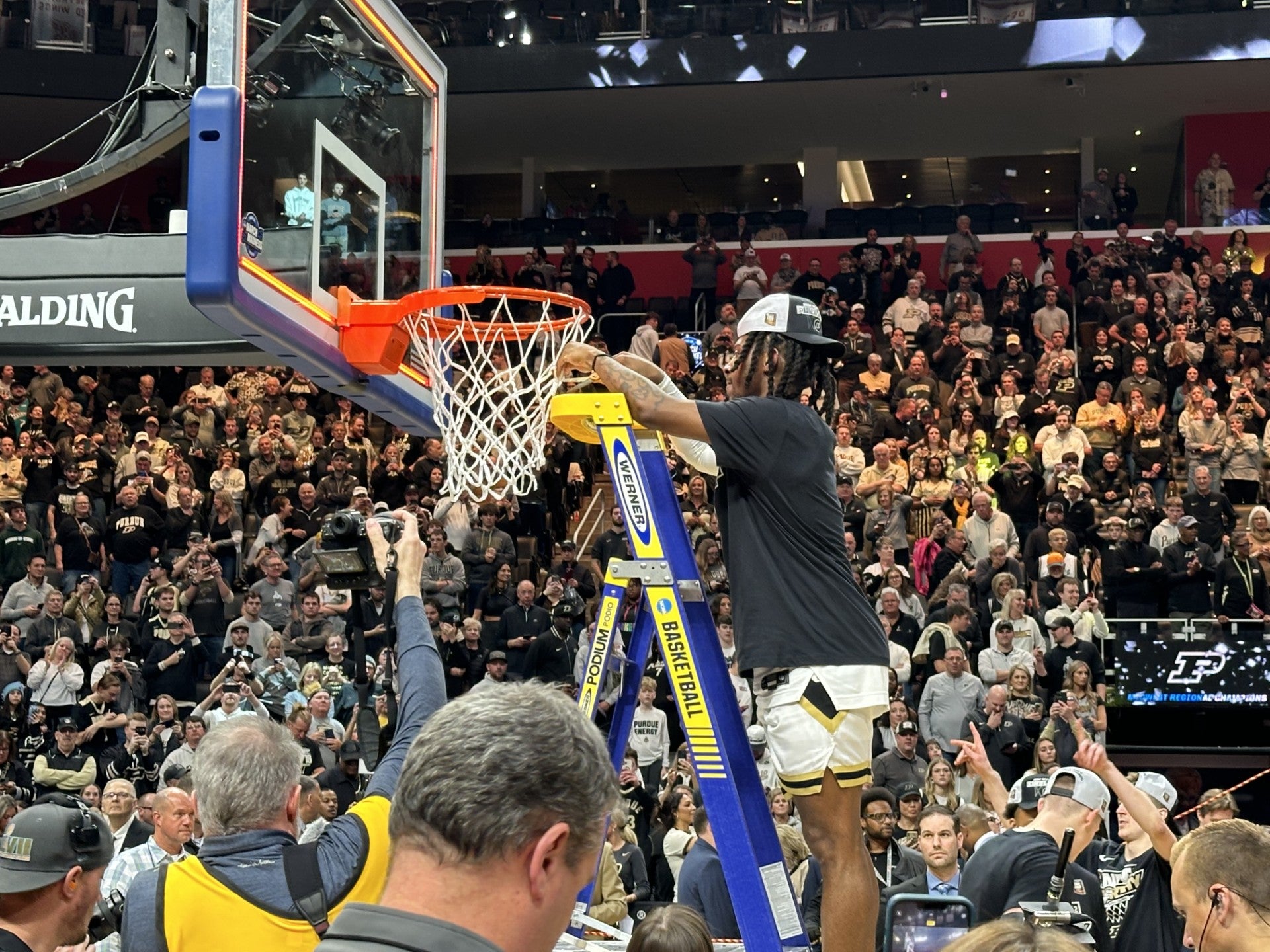 Lance Jones #55 of the Purdue Boilermakers cuts down a piece of the net after defeating Tennessee Volunteers in the Elite 8 round of the NCAA Men's Basketball Tournament at Little Caesars Arena on March 31, 2024 in Detroit, Michigan. (WISH Photo/Andrew Chernoff)