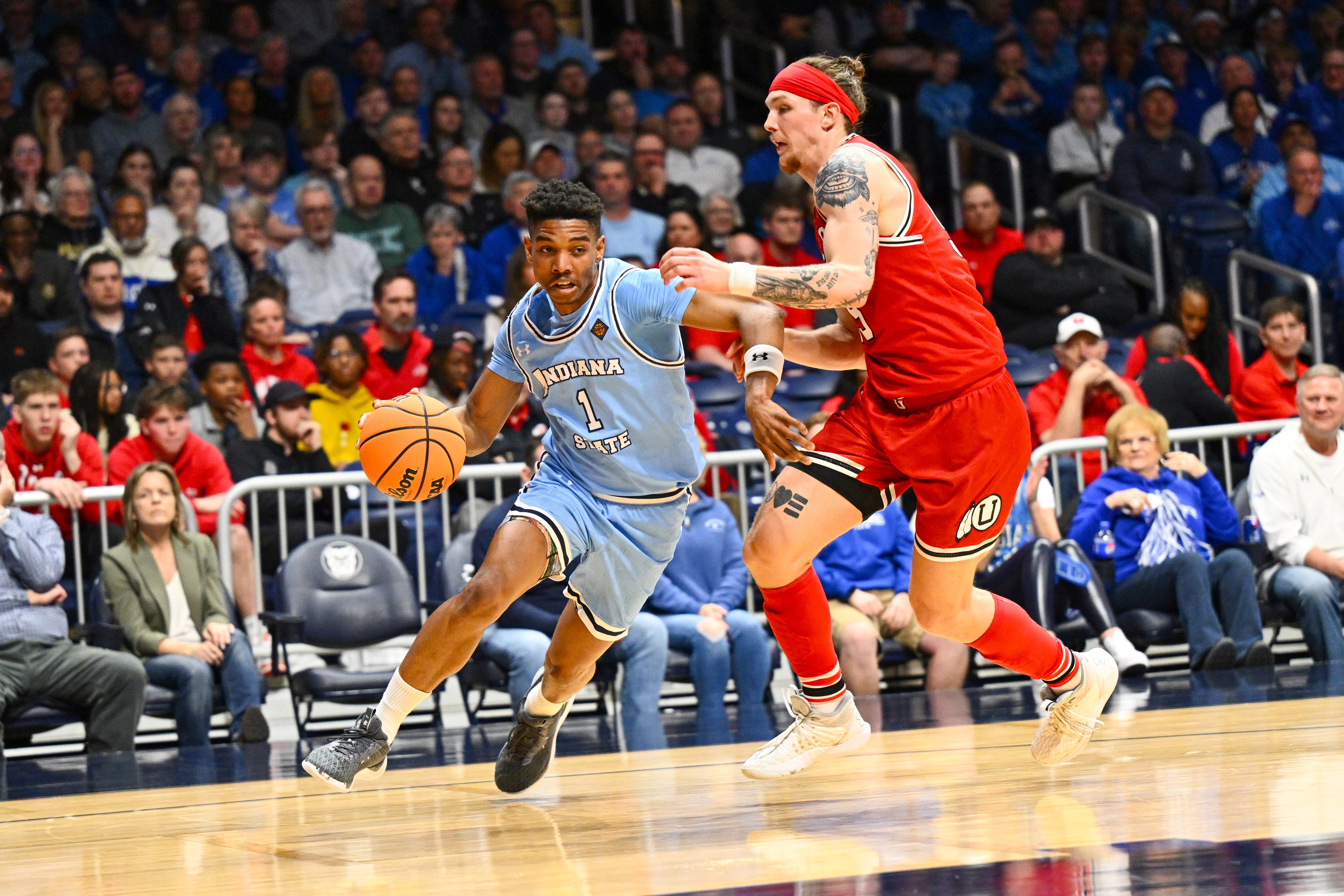 Julian Larry #1 of the Indiana State Sycamores drives baseline against Gabe Madsen #55 of the Utah Utes during the first half of a NIT semifinals held at Hinkle Fieldhouse on April 2, 2024 in Indianapolis, Indiana. (Photo by Jamie Sabau/NCAA Photos via Getty Images)