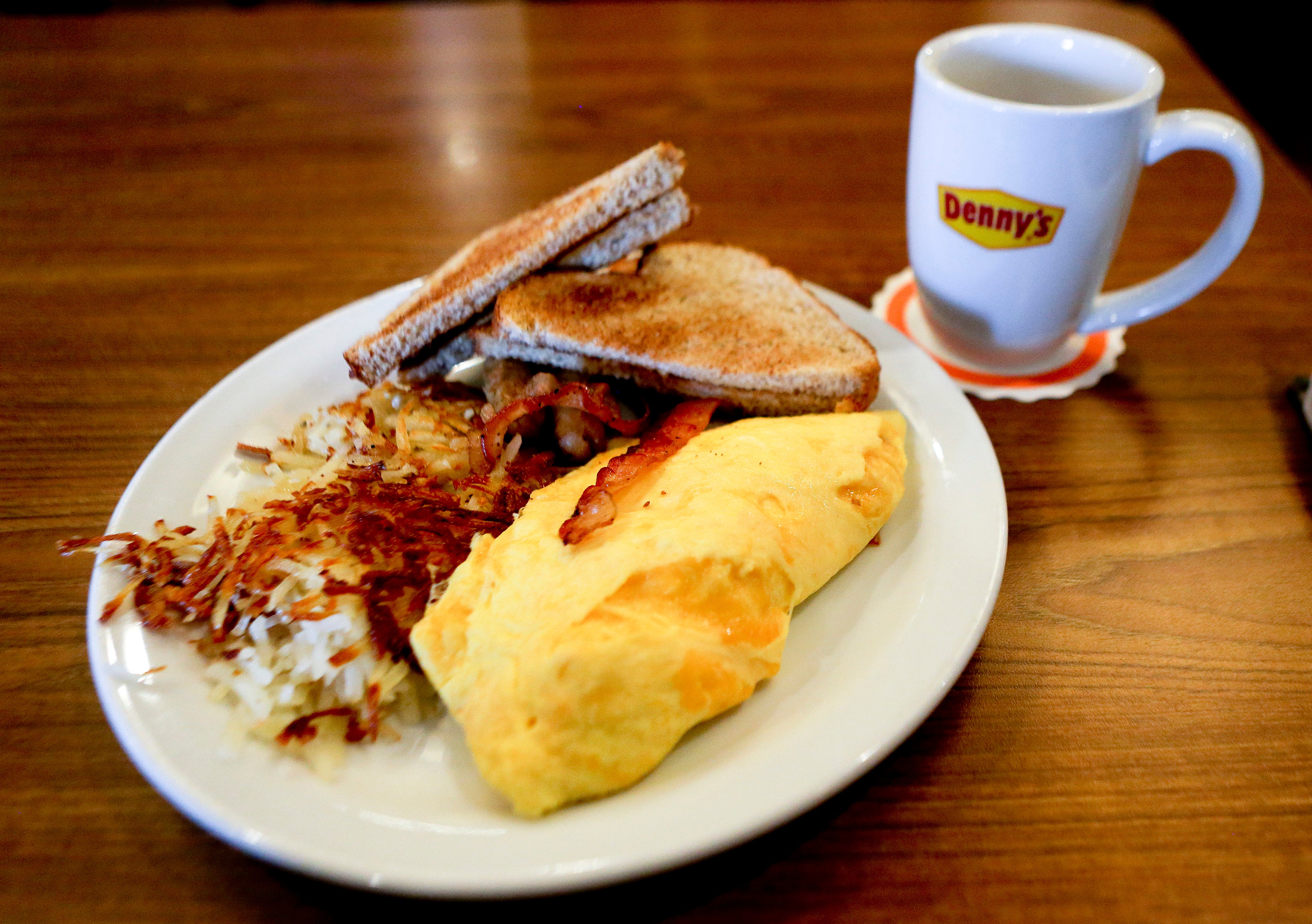 An All-American Slam breakast with whole wheat toast and a side cup of decaffeinated coffee is served at a Denny's restaurant, Thursday, Sept. 14, 2017, in Cranberry, Pa.