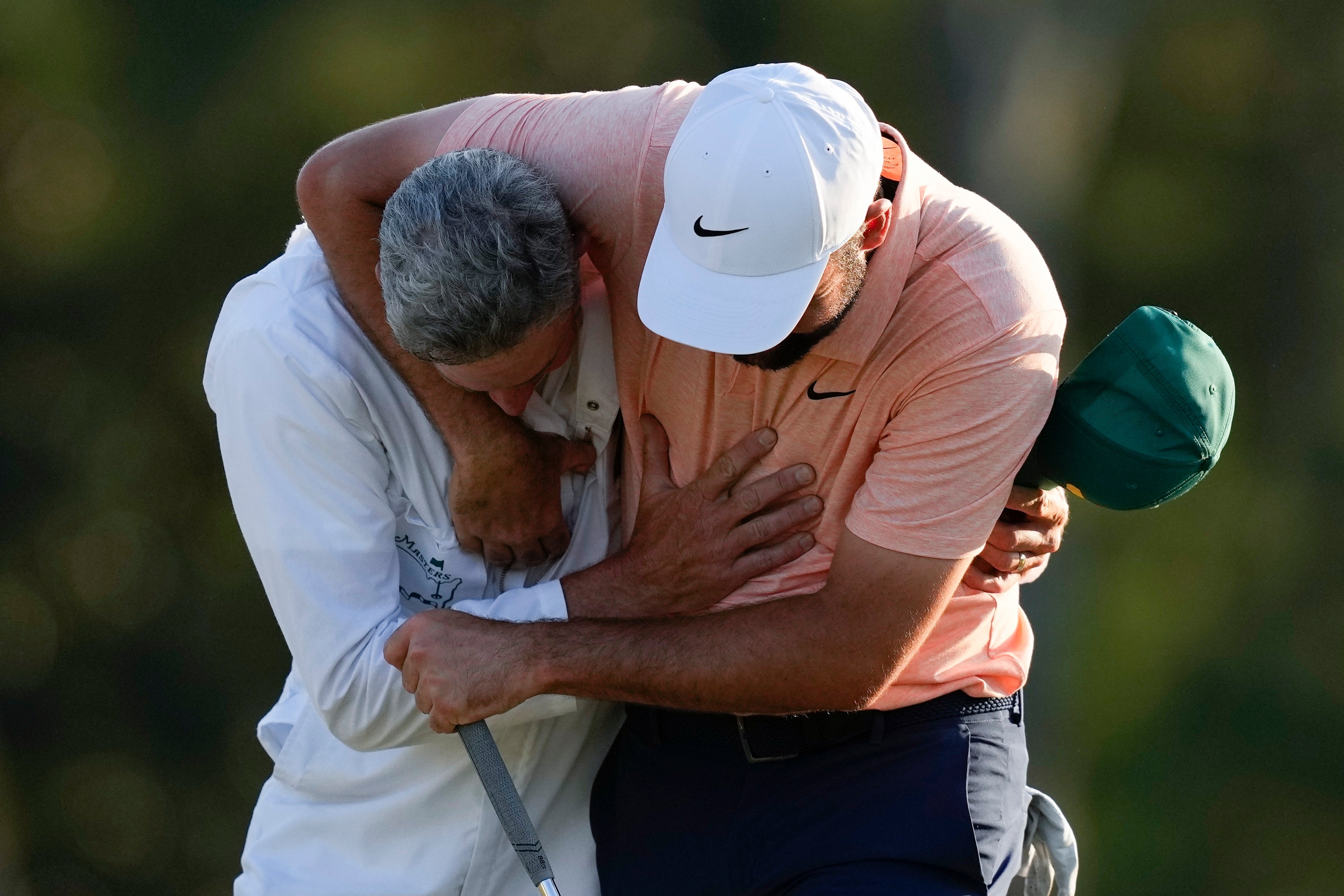 Scottie Scheffler celebrates with his caddie Ted Scott after winning the Masters golf tournament at Augusta National Golf Club Sunday, April 14, 2024, in Augusta, Ga. (AP Photo/David J. Phillip)