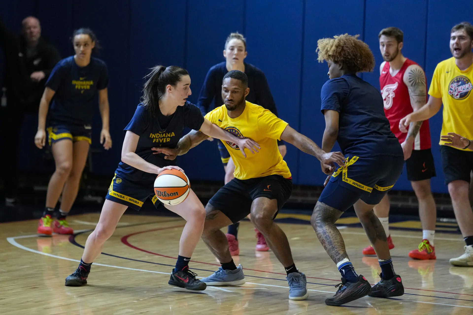 Indiana Fever guard Caitlin Clark, front left, makes a play against the practice squad as the WNBA basketball team works out in Indianapolis, Sunday, April 28, 2024.