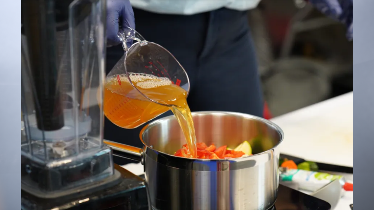 Julia Sluis, a nutritionist at the Marion County Public Health Department, creating the sneaky tomato sauce. (Photo by Jennifer Wilson Bibbs for Mirror Indy)