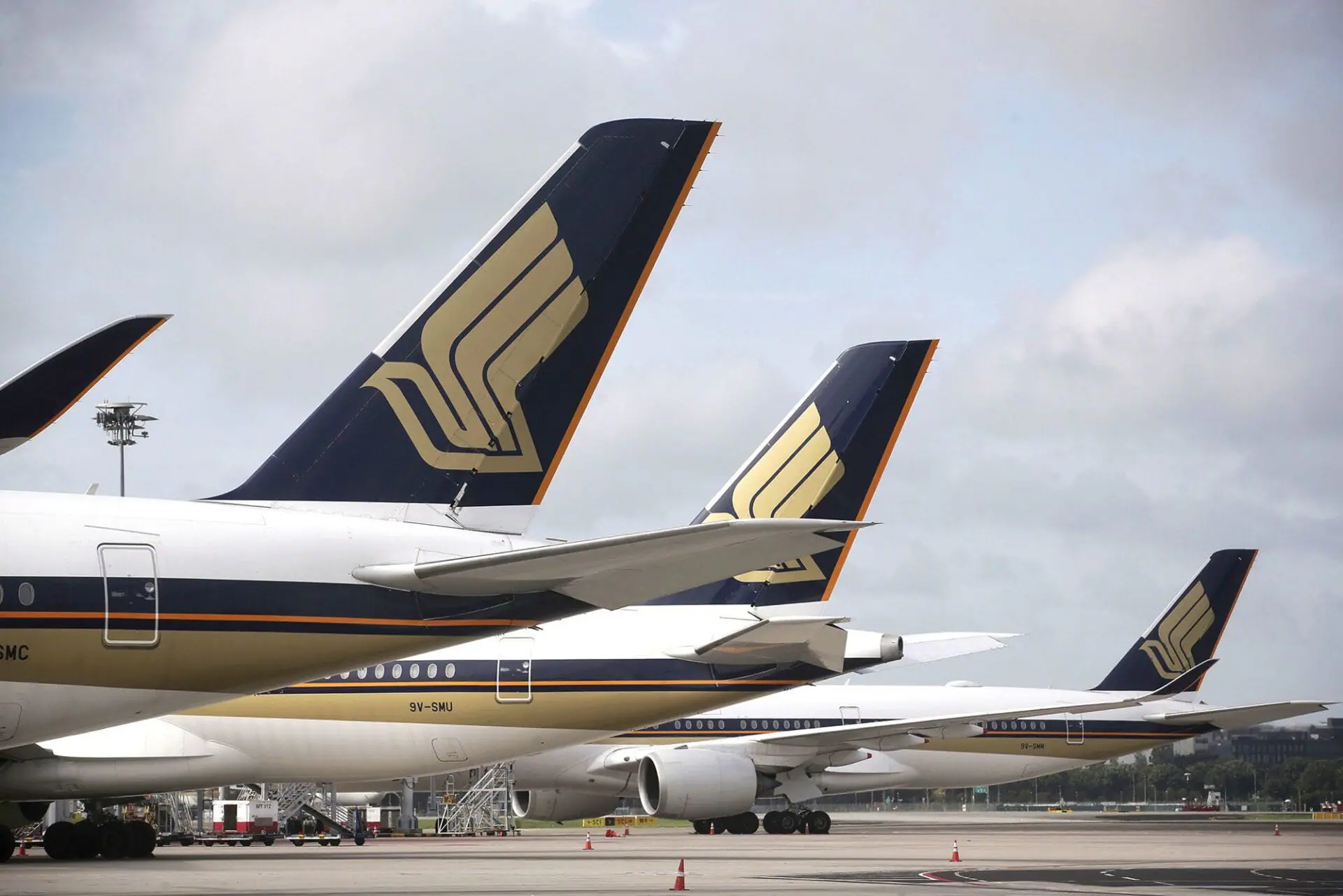 Singapore Airlines planes on the tarmac are seen here in December 2020. At least one person died after a Singapore Airlines flight encountered severe turbulence. (Photo by Kevin Lim/AP via CNN Newsource)