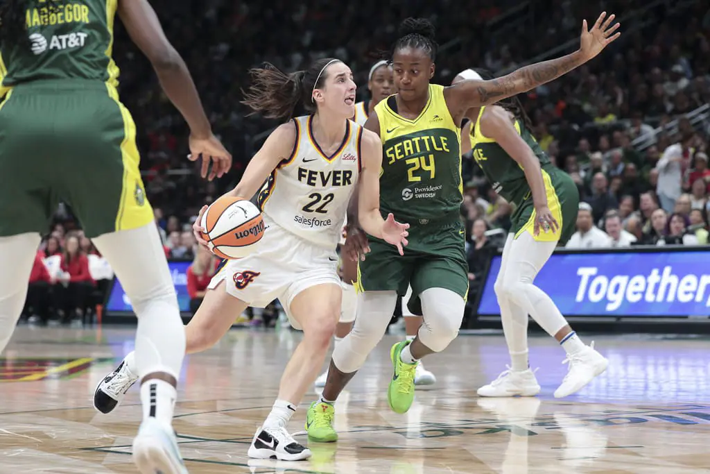 Indiana Fever guard Caitlin Clark (22) drives as Seattle Storm guard Jewell Loyd (24) defends during the second half of a WNBA basketball game, Wednesday, May 22, 2024, in Seattle. The Storm won 85-83. (AP Photo/Jason Redmond)