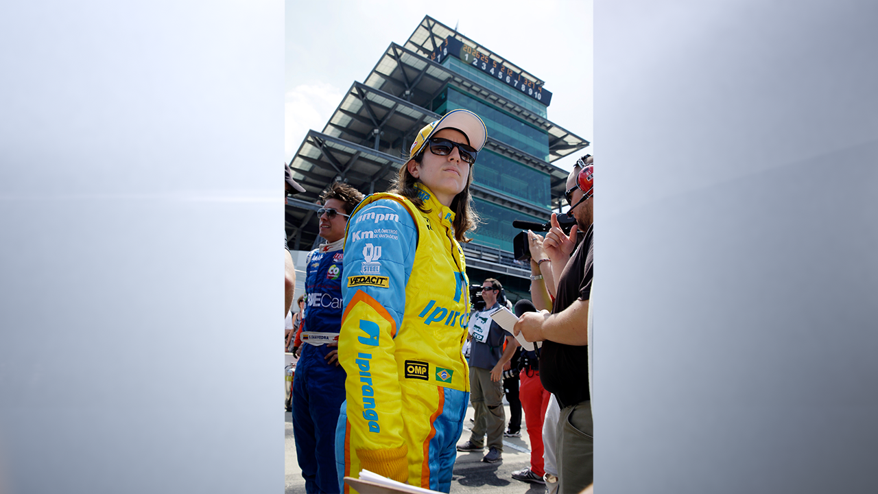 In this photo taken on Sunday, May 19, 2013, Ana Beatriz, of Brazil, stands in the pits after the second day of qualifications for the Indianapolis 500 auto race at the Indianapolis Motor Speedway in Indianapolis. Beatriz is one of four women starting Sunday's race. (AP Photo/Tom Strattman)