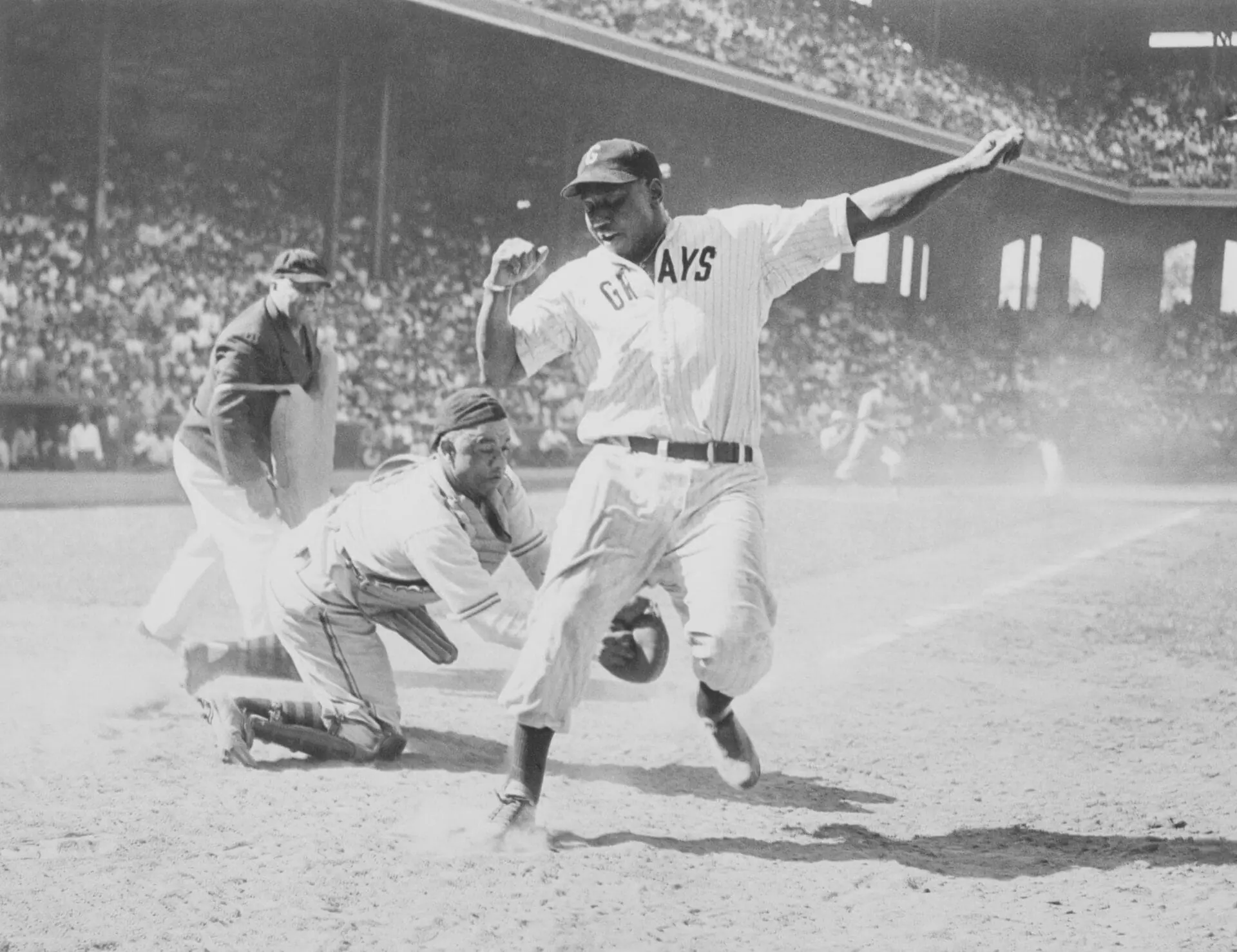 Josh Gibson of East is out at home in the fourth inning of the 12th annual East-West All Star Negro baseball game at Comiskey Park. Gibson was put out by Ted Radcliffe of the West. The West won, 7 to 4. (Photo by Bettmann/Getty Images)