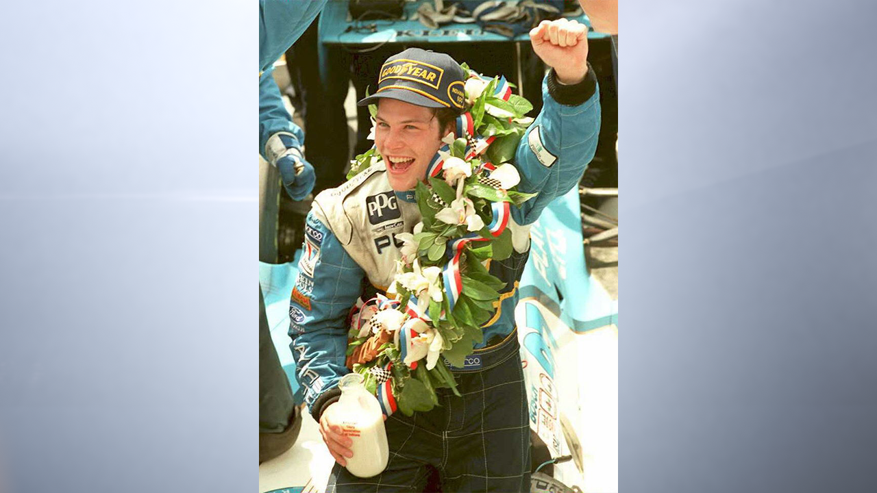 Canadian Indy car driver Jacques Villeneuve celebrates his victory 28 May after winning the 79th Indianapolis 500. Villeneuve won the Indy 500 in his second attempt. (Photo by AFP via Getty Images)