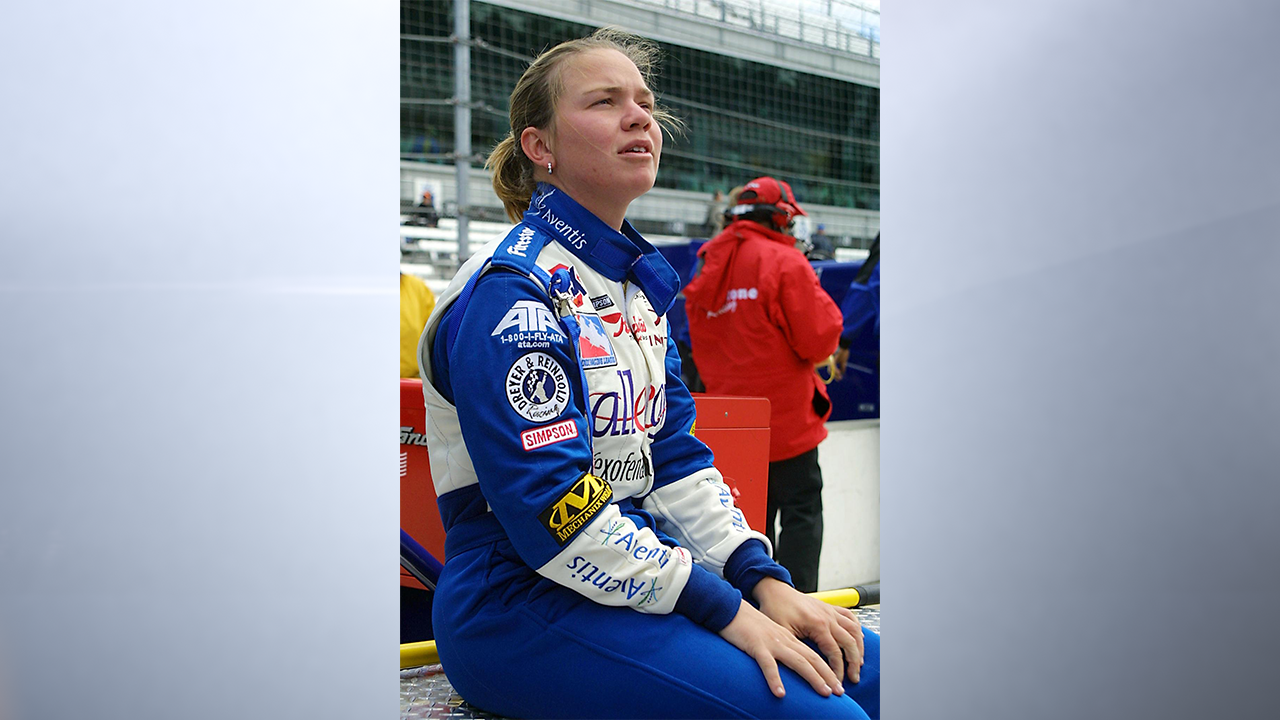 Sara Fisher of the US sits on the pit wall 18 May 2002 at the Indianapolis Motor Speedway in Indianapolis, IN. Fisher will be the fastest women to ever start the 86th running of the 500 will be held on 26 May. AFP PHOTO/Ann MILLER CARR (Photo by ANN MILLER CARR / AFP) (Photo credit should read ANN MILLER CARR/AFP via Getty Images)