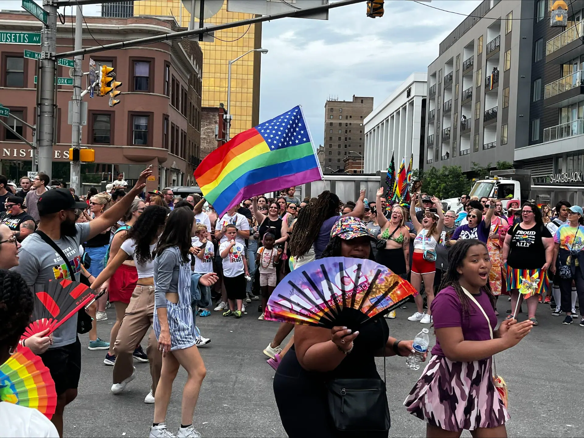 People march and wave flags in the 2024 Indy Pride Parade.