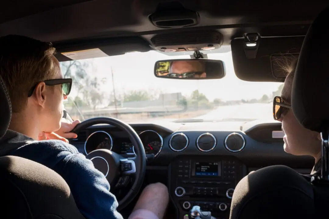 A driver and passenger, driving down the road. Indiana has the highest failure rates for its driver’s license test in the U.S., with more than 1,362,100 Hoosiers failing the test from 2020 to 2023, according to a recent USA Today report. The inability to pass the test can harm residents in Indiana, one of the most car-dependent states in the country. (Moment Unreleased via Getty Images)