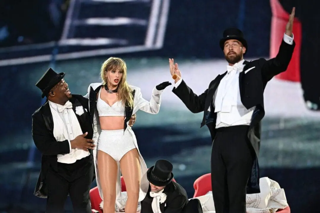 Taylor Swift is joined on stage by Travis Kelce (R), during 